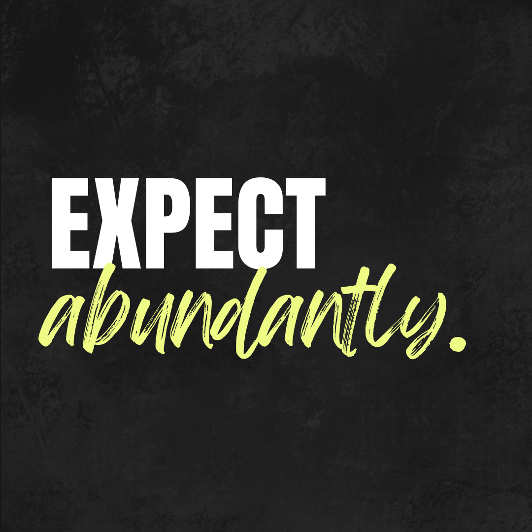 Quote on black background that says "Expect abundance" with 'Expect' in bold white font and 'abundance' in cursive light green font.