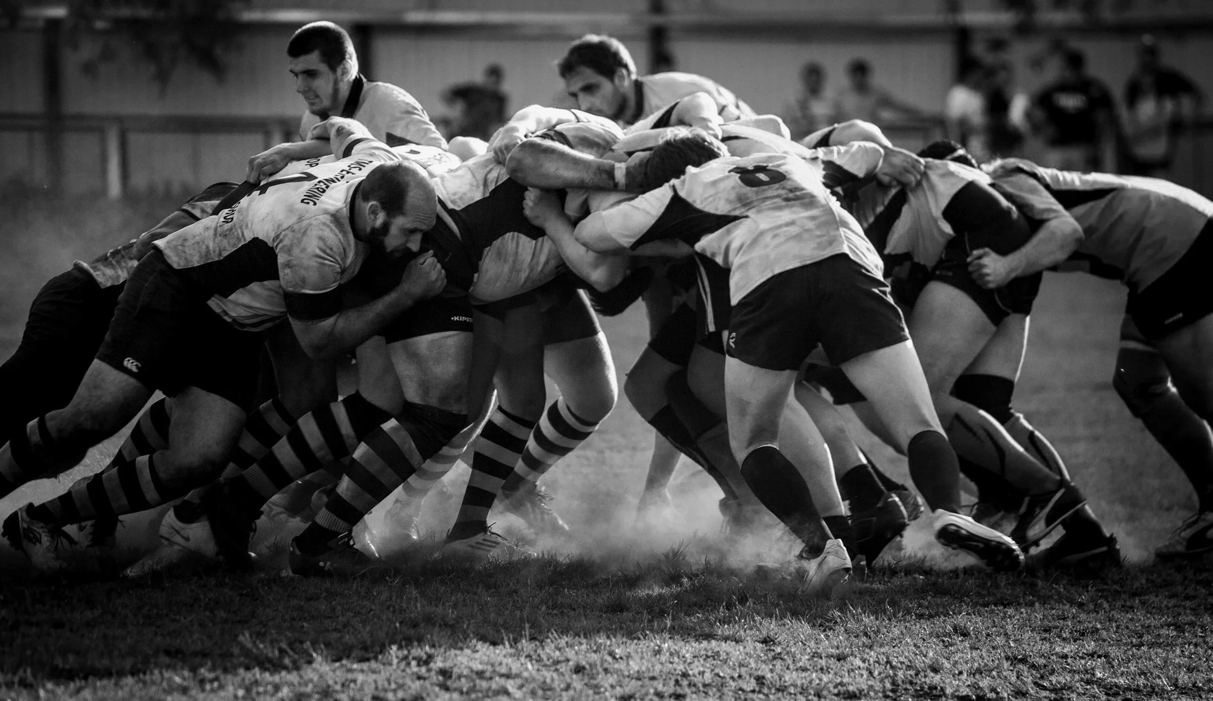 Rugby players in a scrum — representing team performance, collective pressure, and the mental demands of competitive sport.
