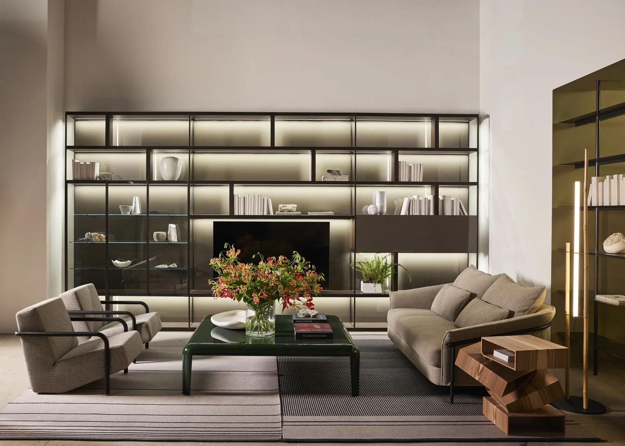 Porro-New-York-Flagship_13_Living-Area_System-HT-shelving-Ferro-low-table-Kite-Sofa-Lullaby-armchair-and-Balancing-Boxes-side-table_.webp