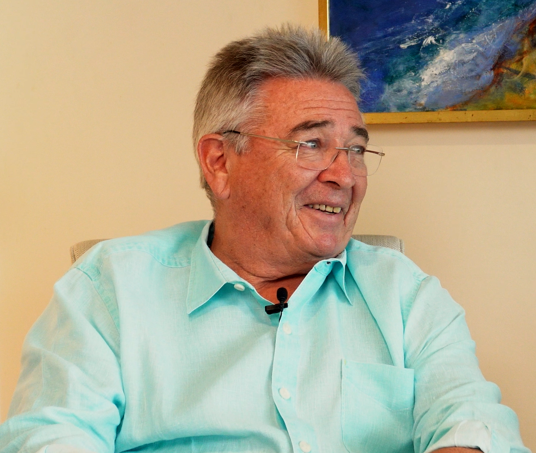 Richard "Dick" Gorman, co-host of this podcast about Prostate Cancer, sits laughing and looking to the right.