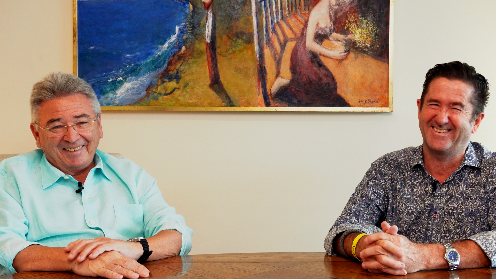 Dick and Steve, the hosts of a podcast about prostate cancer, sit smiling at a table