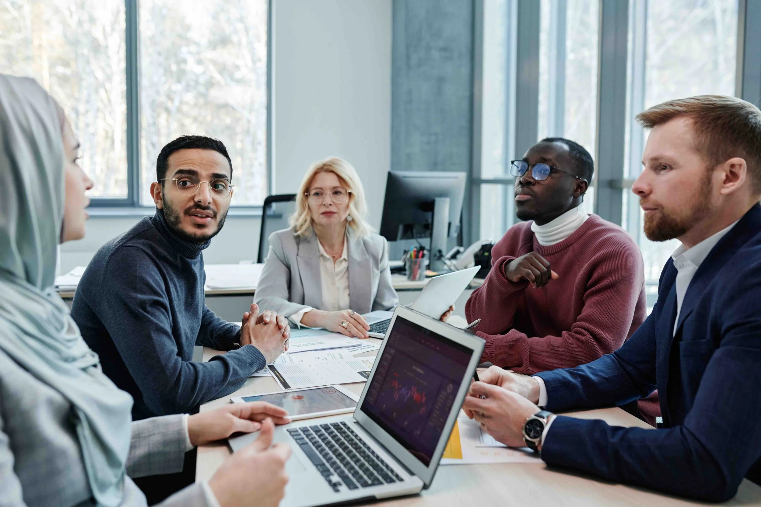Business professionals meeting in a modern office to discuss risk management strategies, insurance solutions, and long-term client value.
