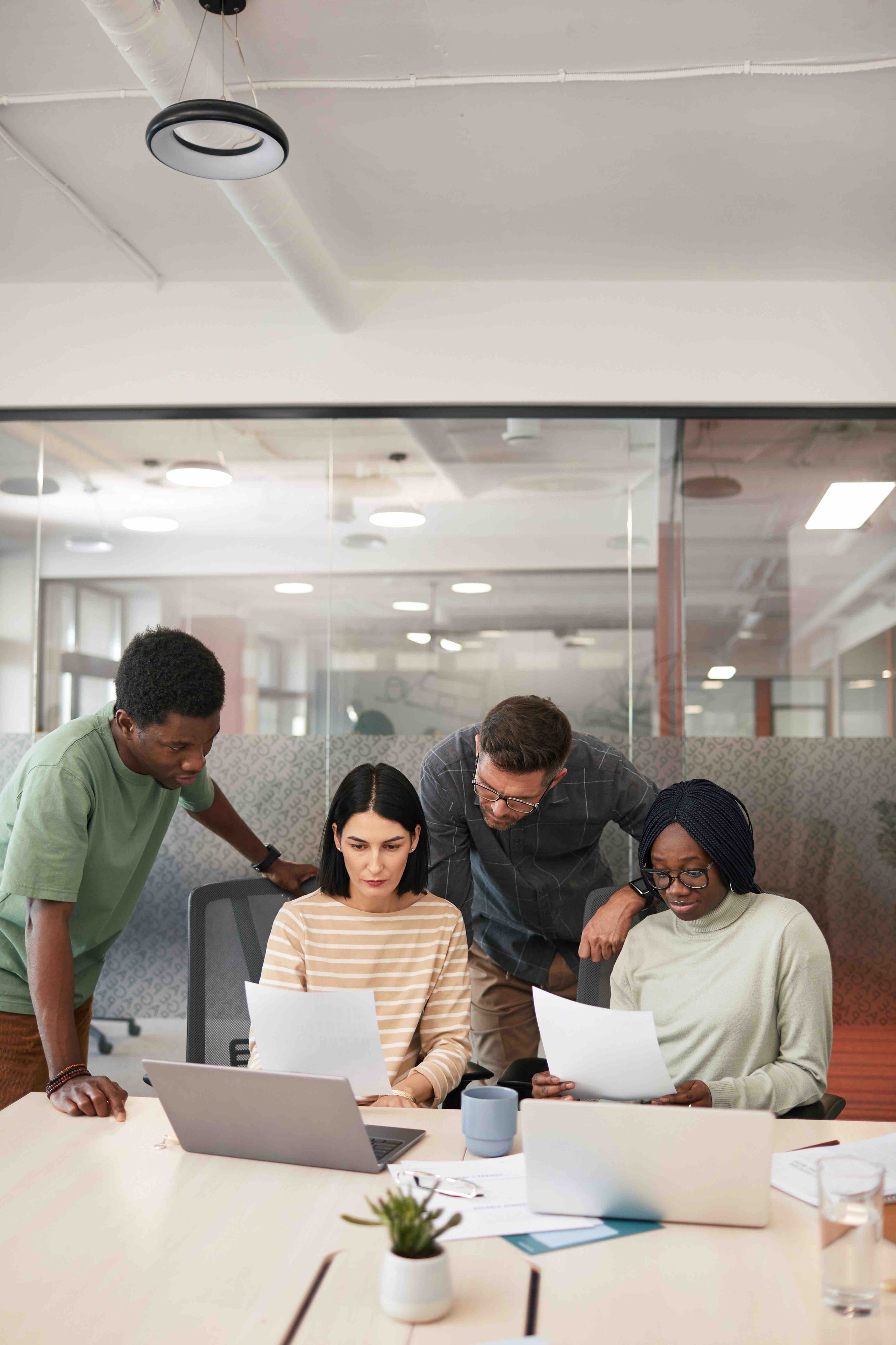 Business professionals reviewing documents and coverage strategies as part of a client joint venture brokerage focused on alignment, accountability, and risk management services.