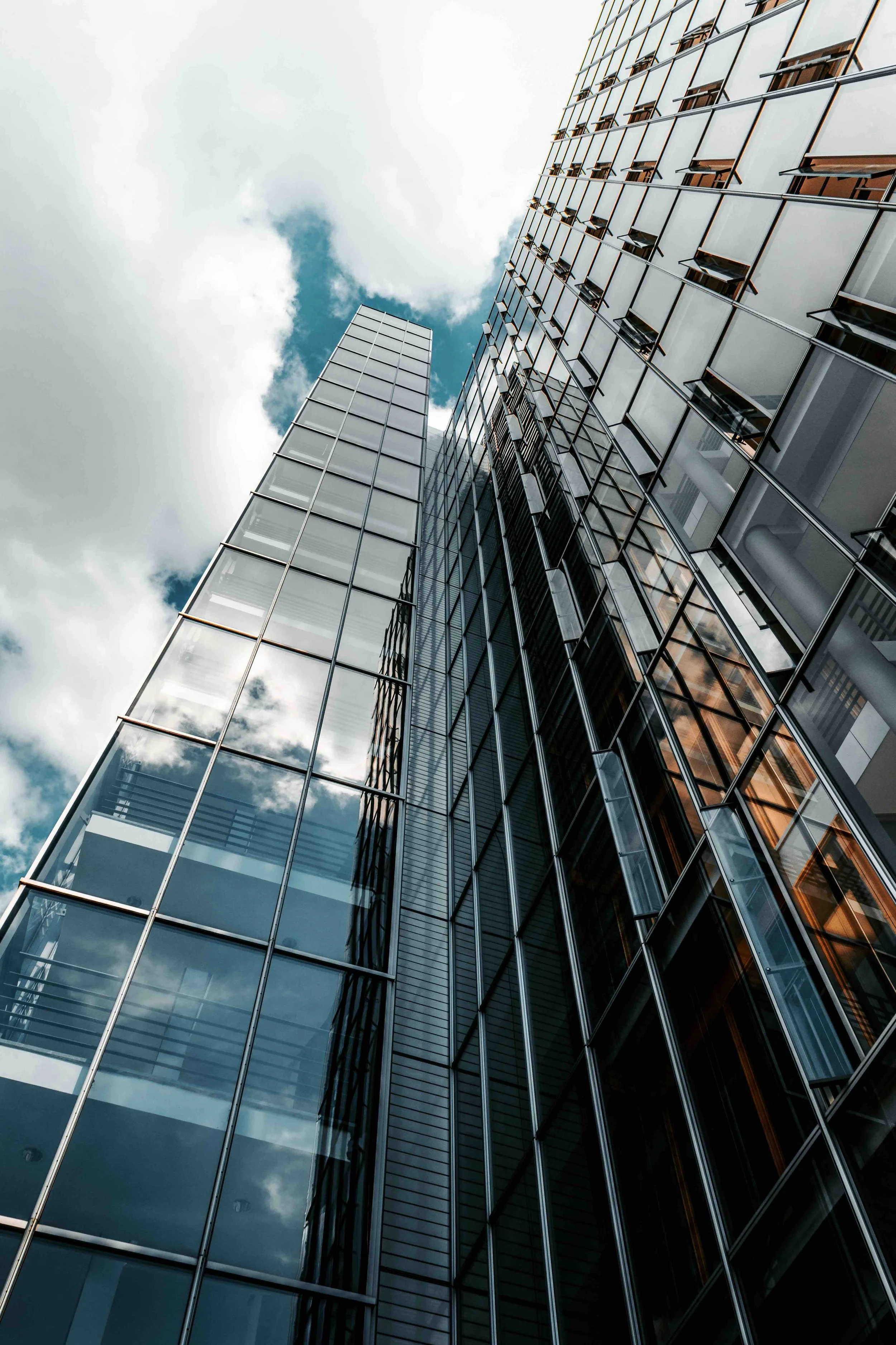 Modern glass office building representing a client owned insurance brokerage that delivers transparent insurance brokerage services, brokerage profit sharing, and long-term client value.