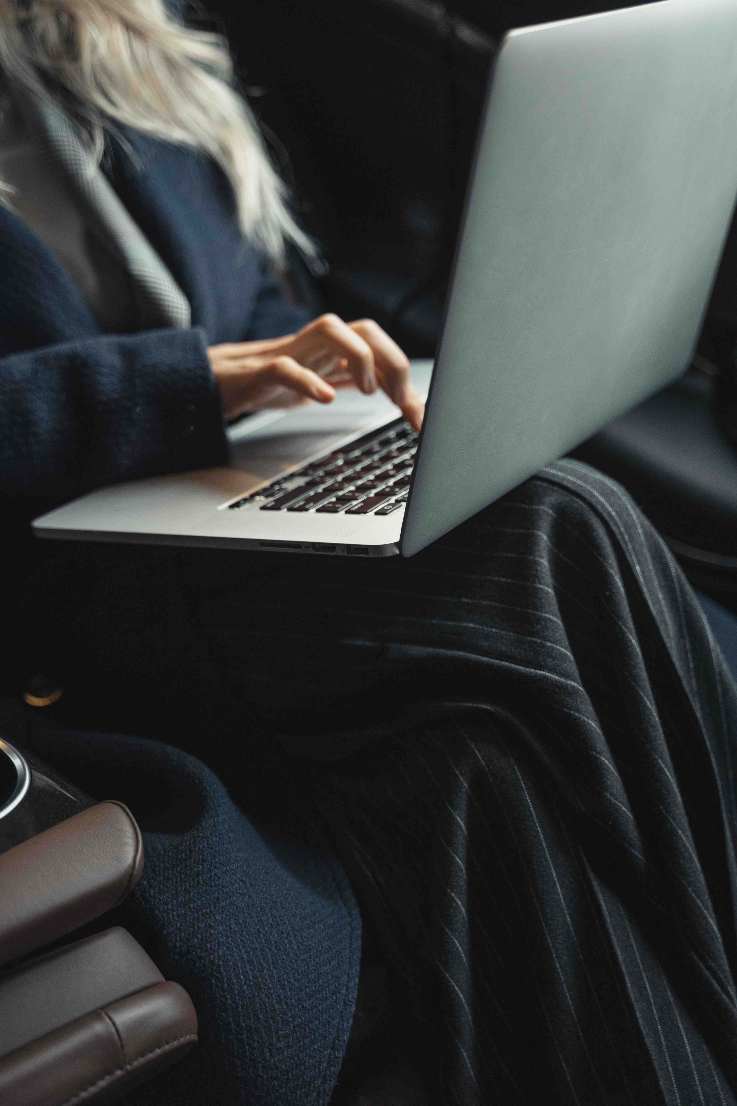 Insurance professional working on a laptop to analyze coverage options, client programs, and insurance participation platform performance.