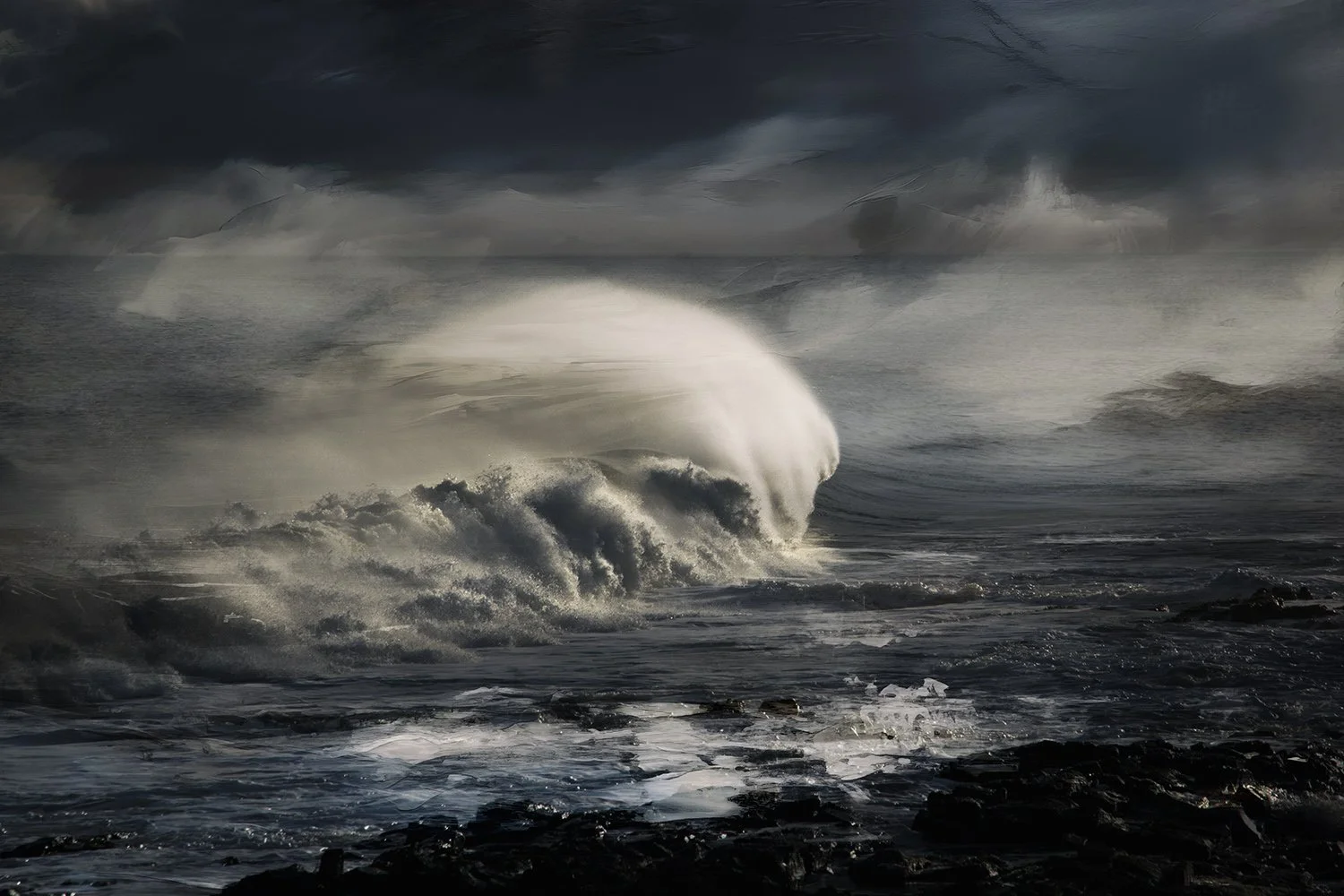 Rough ocean waves crashing against rocks under dark stormy sky.