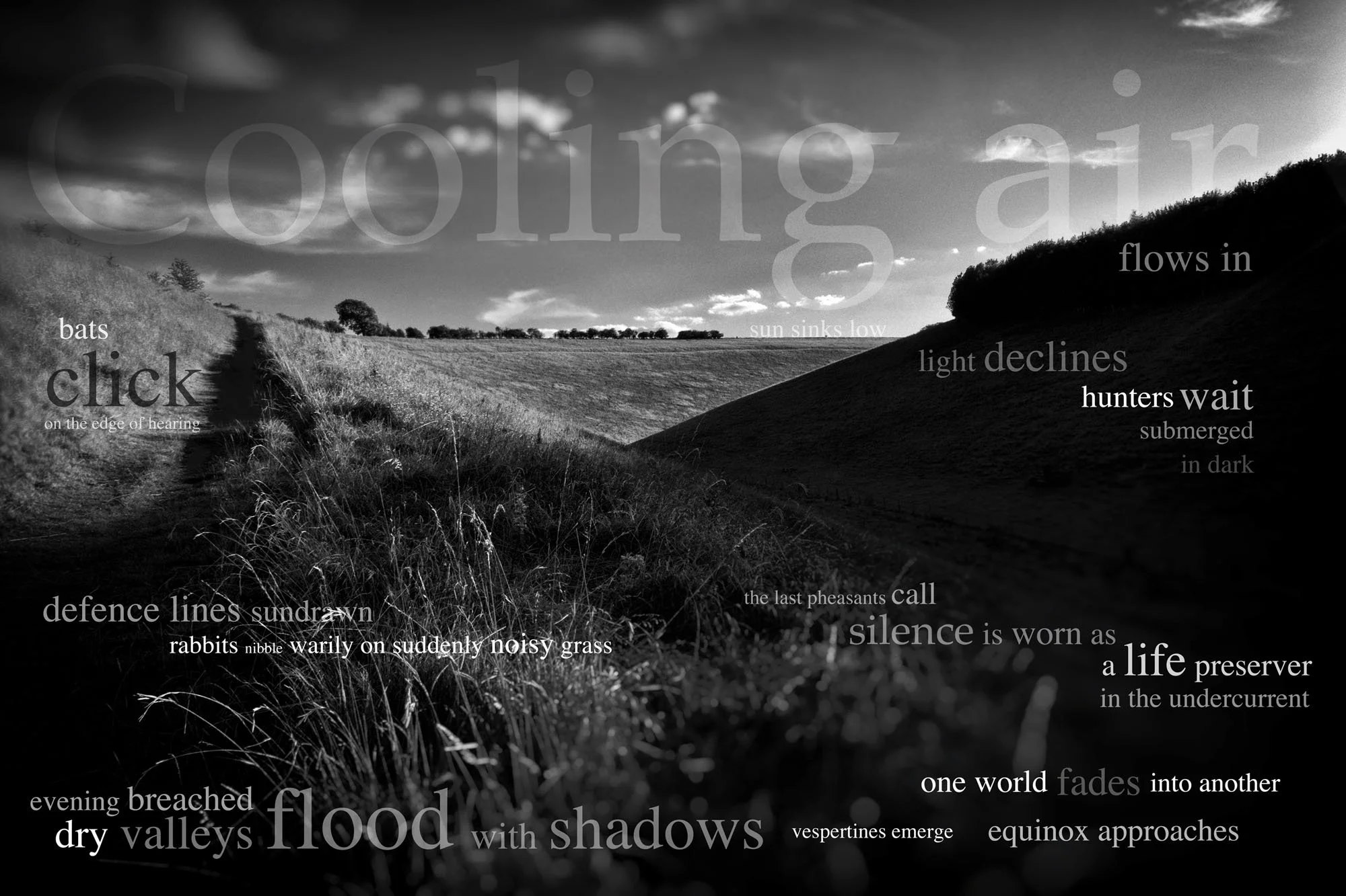 Black and white landscape photograph of rolling hills and fields with a cloudy sky. Words of poetic text are overlaid on the image, including "cooling air flows in," "flood with shadows," "dry valleys," "flood," and "a life preserver."