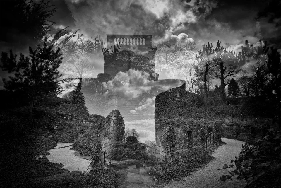 A black and white double exposure photo of a scenic landscape with ruins, trees, a river, clouds, and an architectural structure resembling a temple or monument.