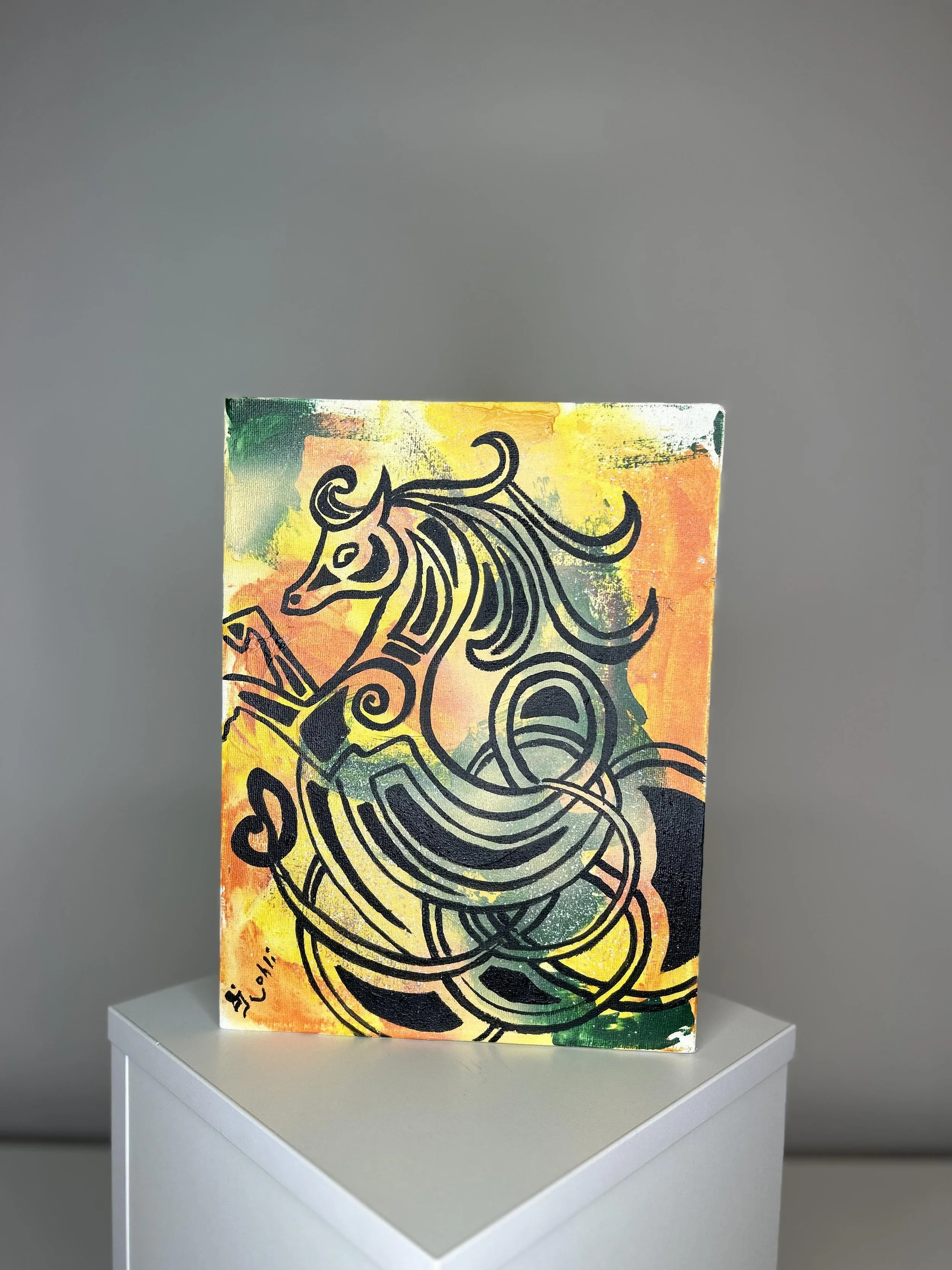 Colorful canvas art featuring a black line drawing of a seahorse with a colorful background, signed 'S. Lowell' at the bottom left corner, displayed on a white pedestal.