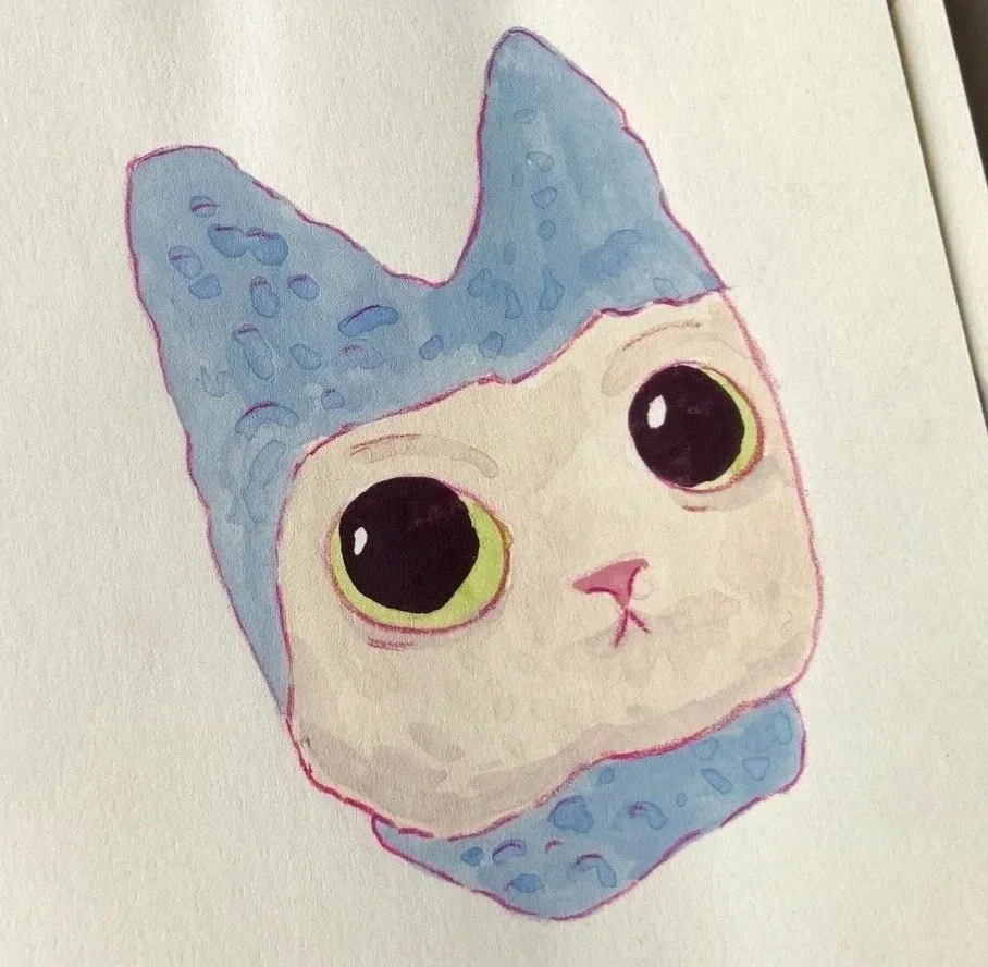A watercolor illustration of a cute cat with large greenish-yellow eyes, wearing a blue hat with cat ears, on cream-colored paper.