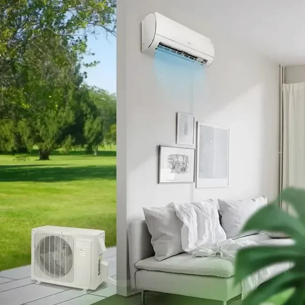 A room with a wall-mounted air conditioner and a portable outdoor unit with a garden view outside.