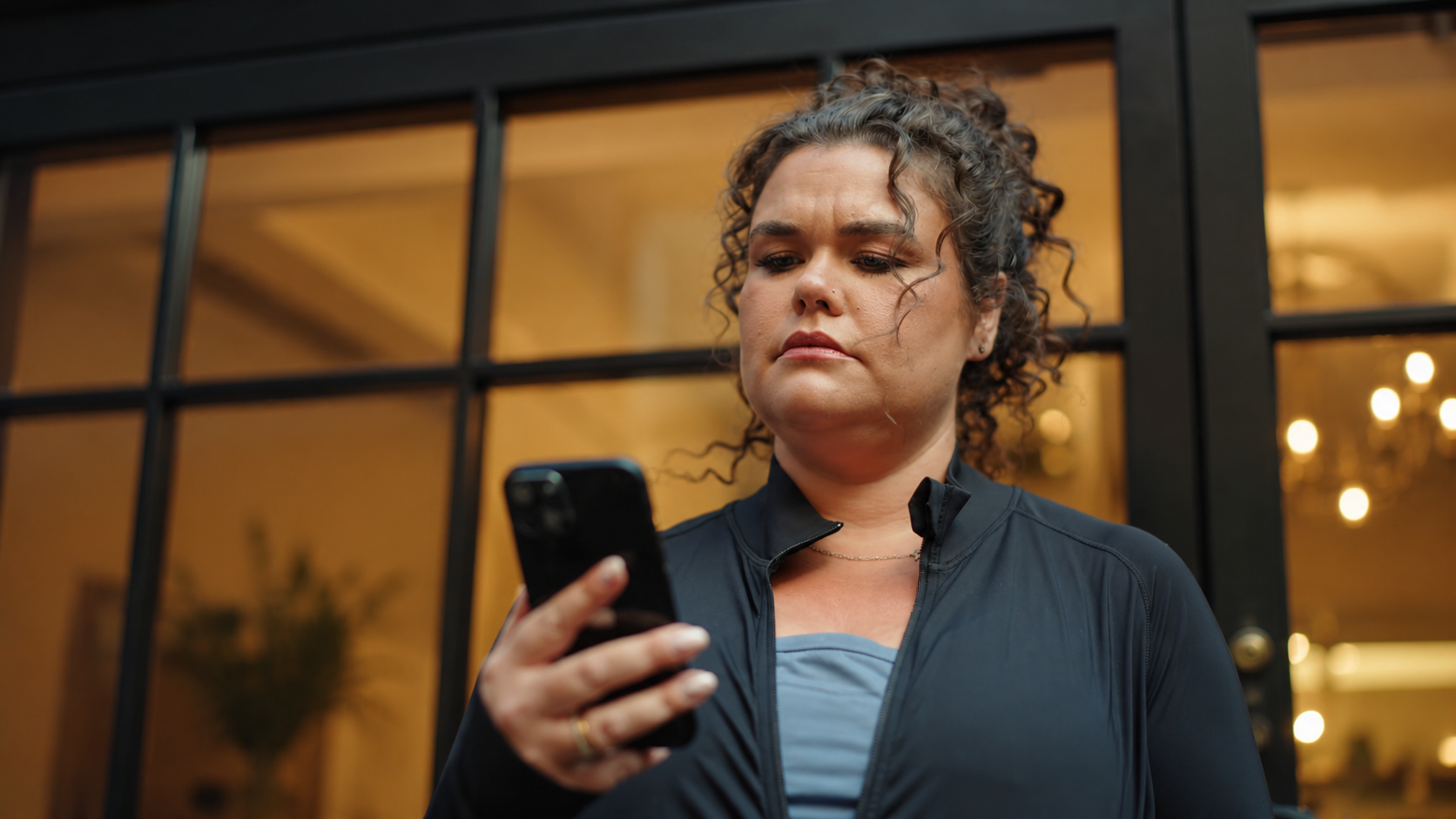 Amy Tapper looking at her phone in an image from the Chemist4U Already Doing It campaign.