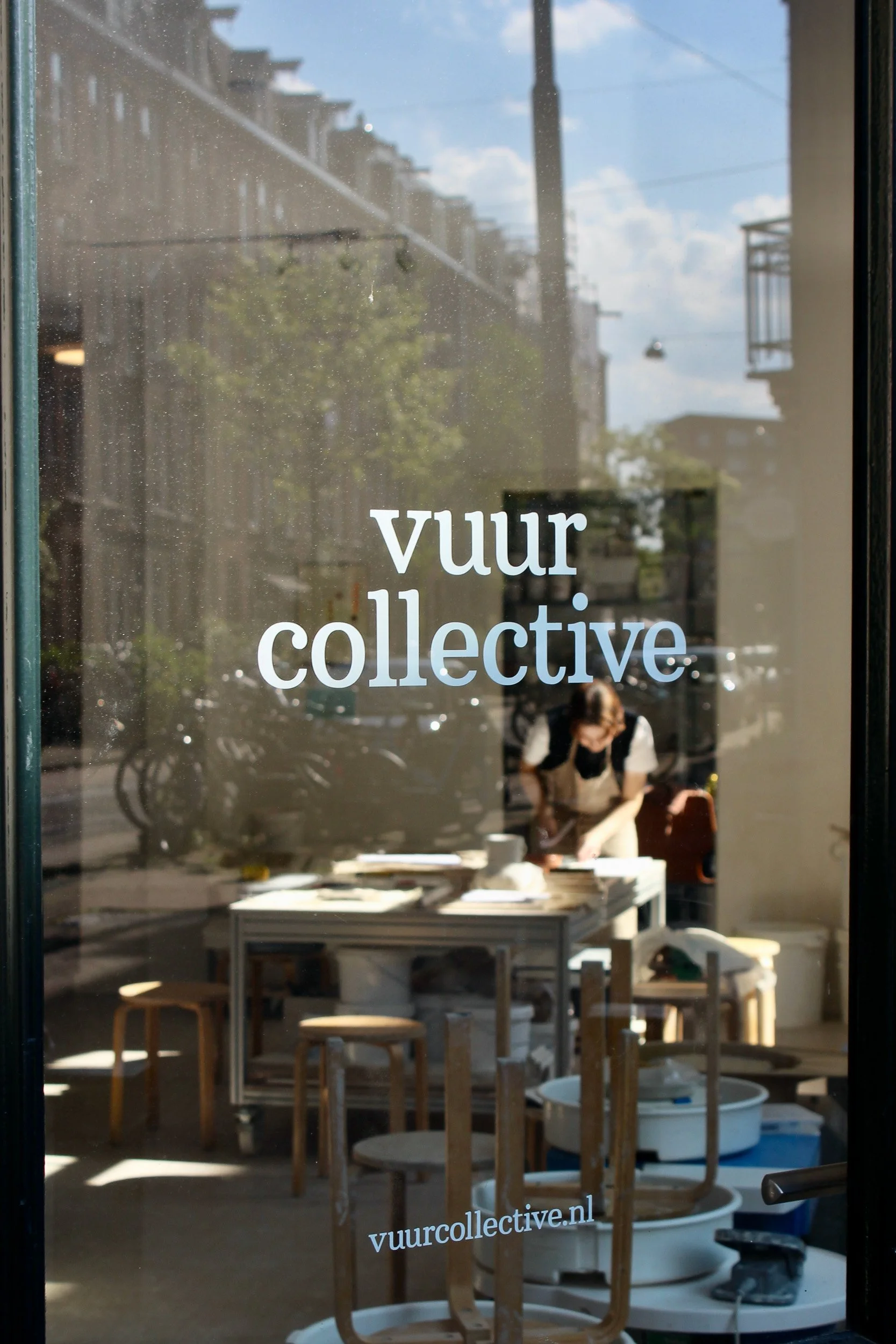 Vuur Collective studio seen through the window, Amsterdam. Behind the scenes photography by Isabel Hachmann-Peralt.