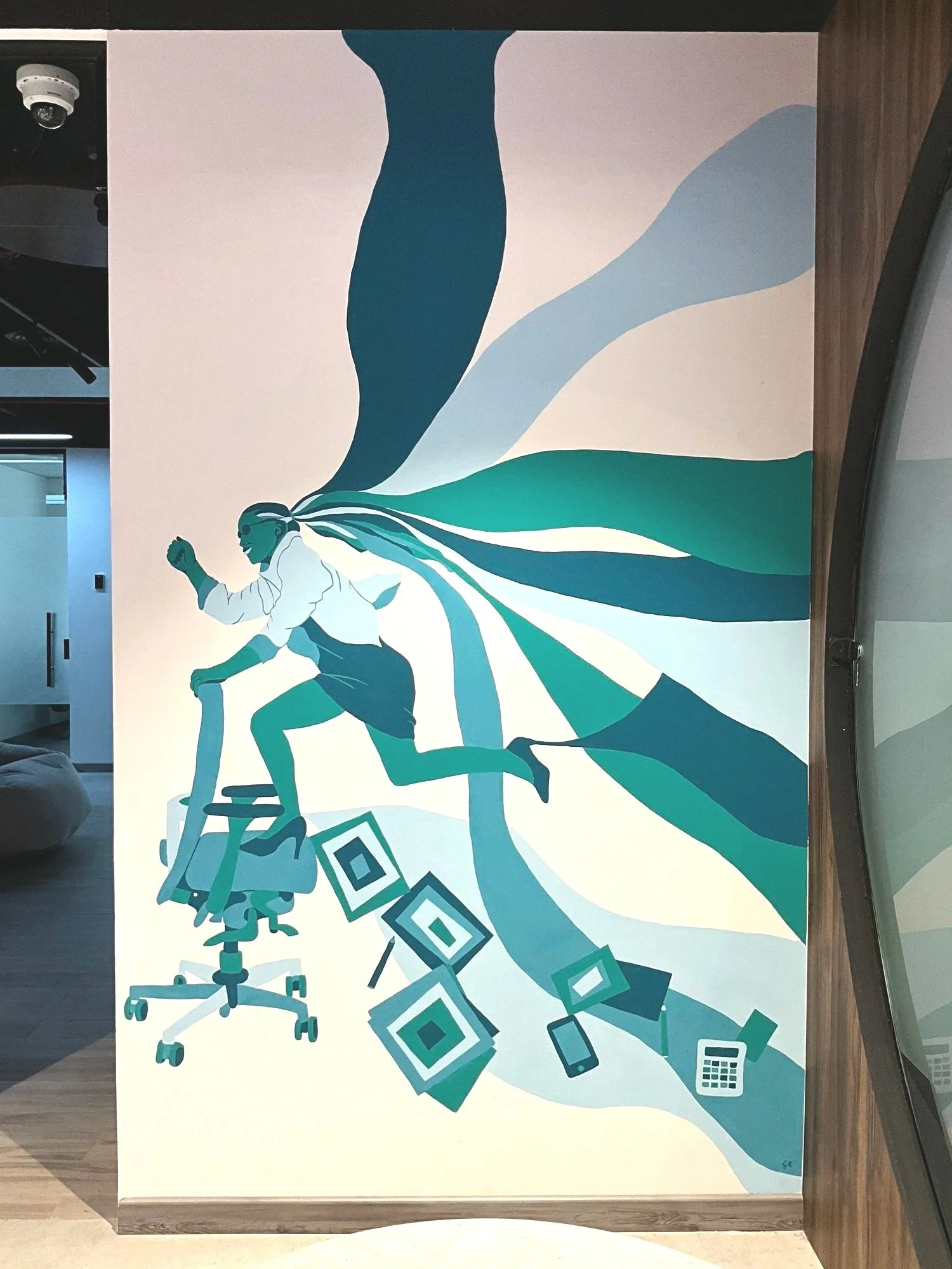 A mural depicting a person running on a chair, surrounded by geometric shapes and electronic devices such as a tablet, phone, laptop, and calculator, with flowing abstract shapes in shades of blue and green.