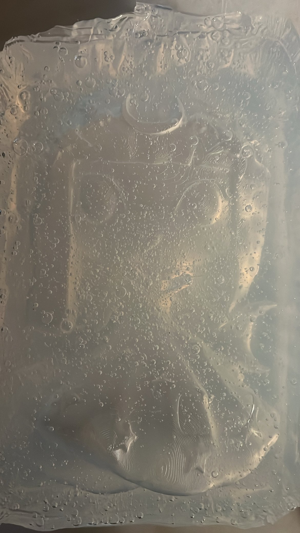 Close-up of a glass surface covered with condensation and water droplets.