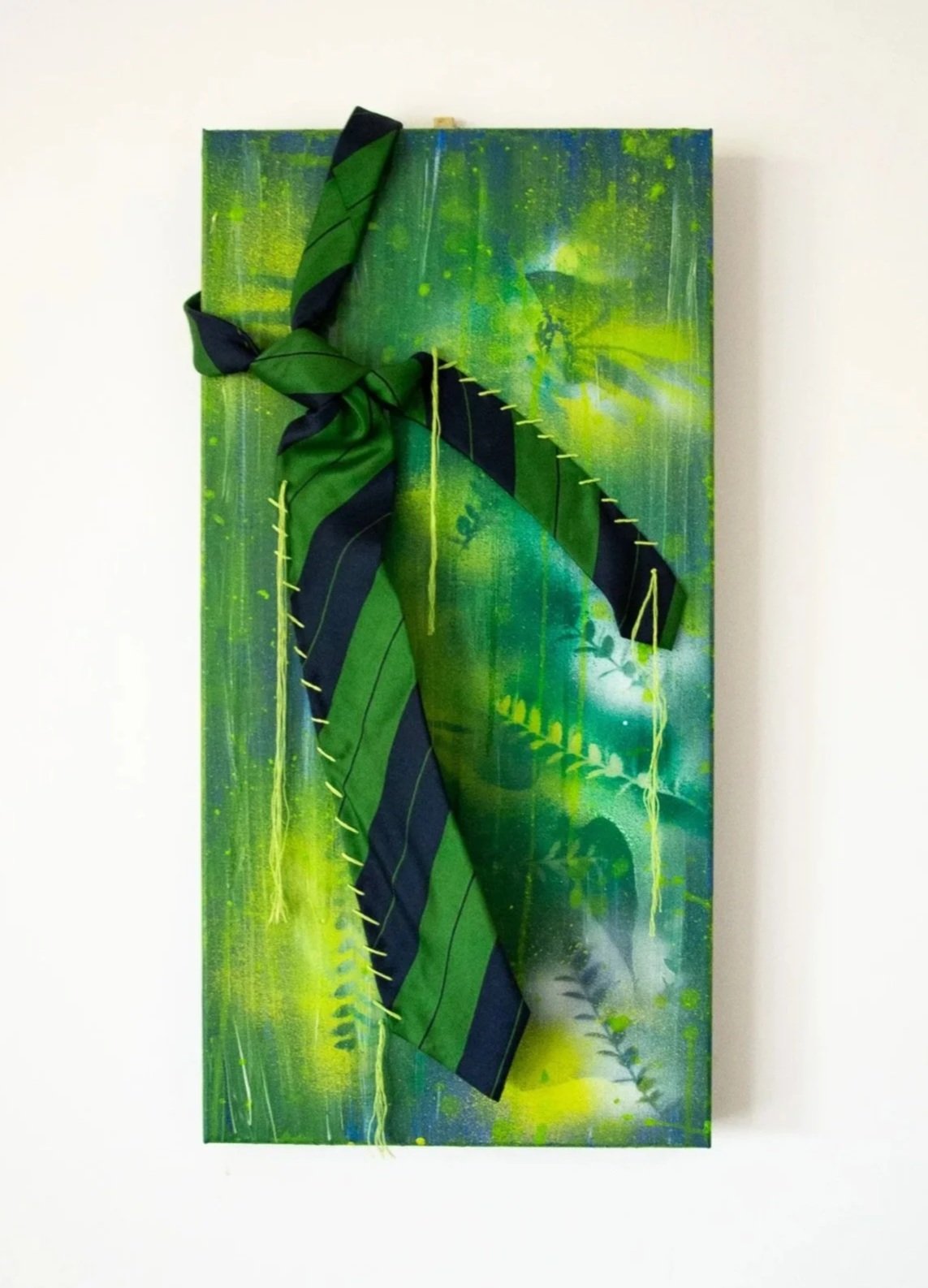 Green and black abstract mixed media artwork with ribbon and stitched fabric accents.