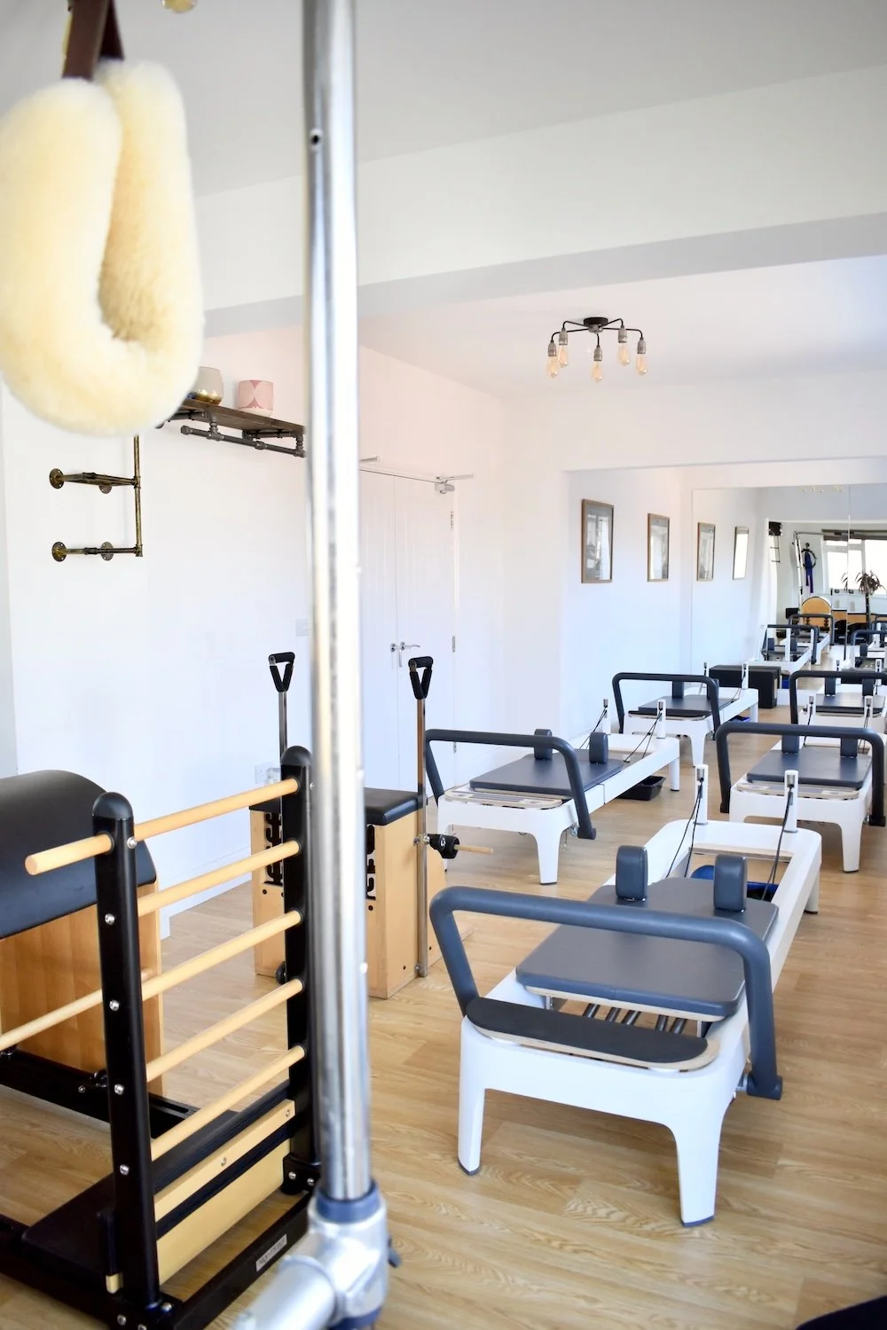 Rows of reformer pilates equipment in Liverpool pilates studio.