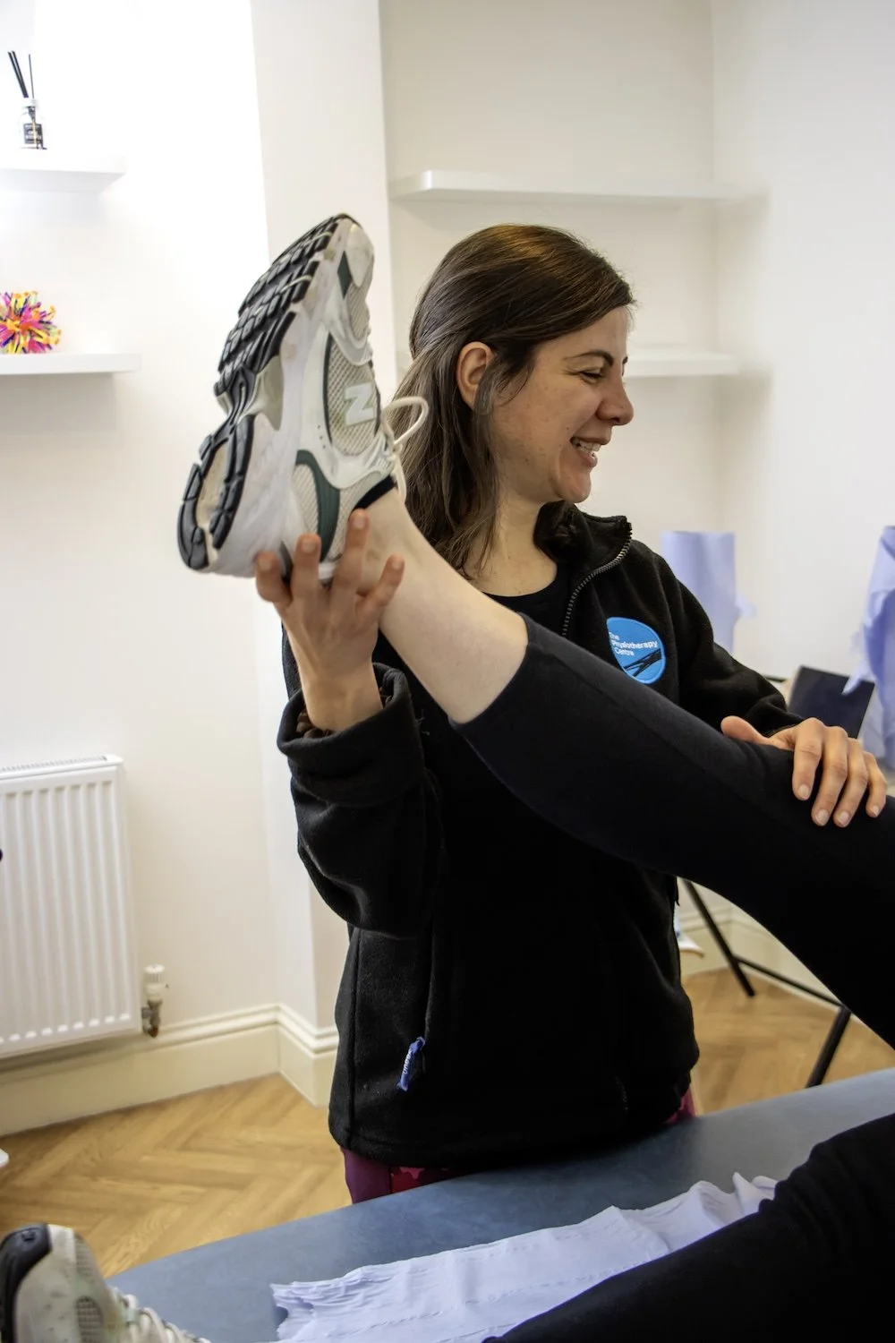 Physiotherapist stretching out a patients knee in a physio clinic.