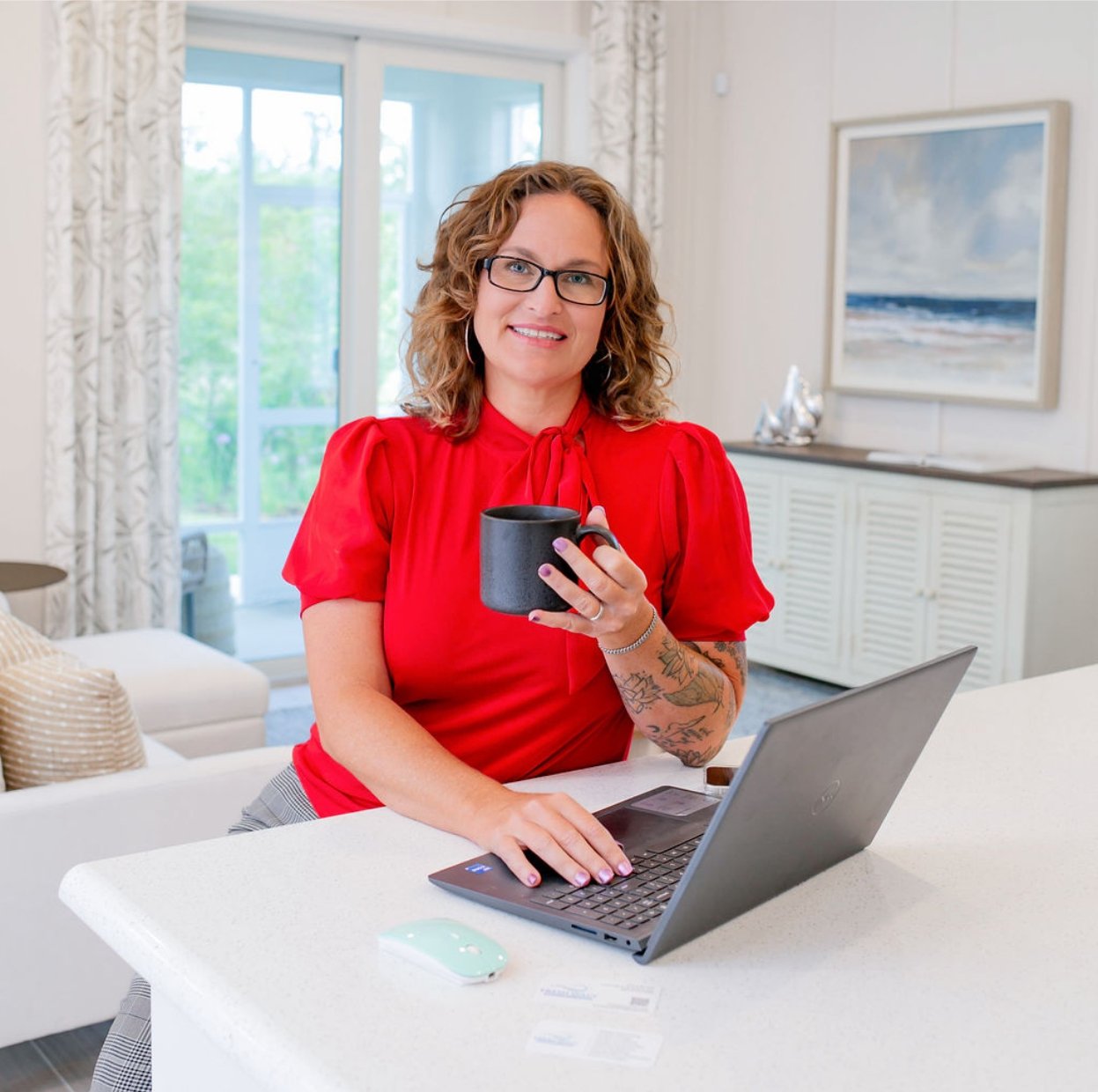 A woman professional graphic designer with a laptop, that designs logos, websites and much more.