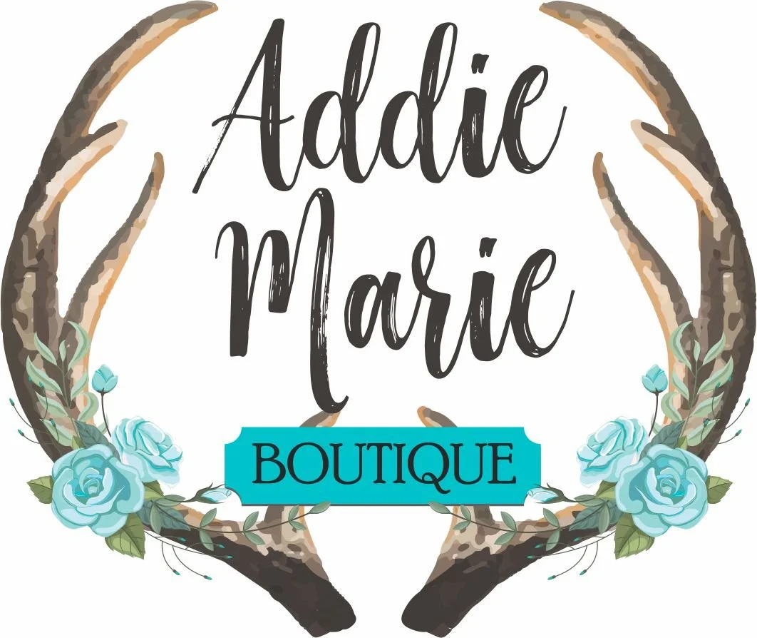A logo for Addie Marie Boutique featuring a pair of hands forming a heart shape, surrounded by light blue roses and green leaves, with the boutique's name in stylish black font and a blue banner.