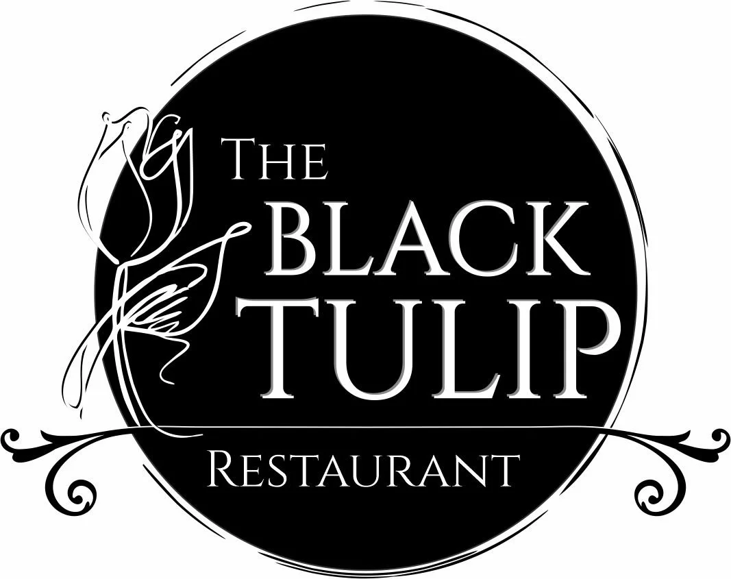 Logo for The Black Tulip Restaurant, featuring a black circle with a stylized tulip illustration to the left and decorative flourishes.