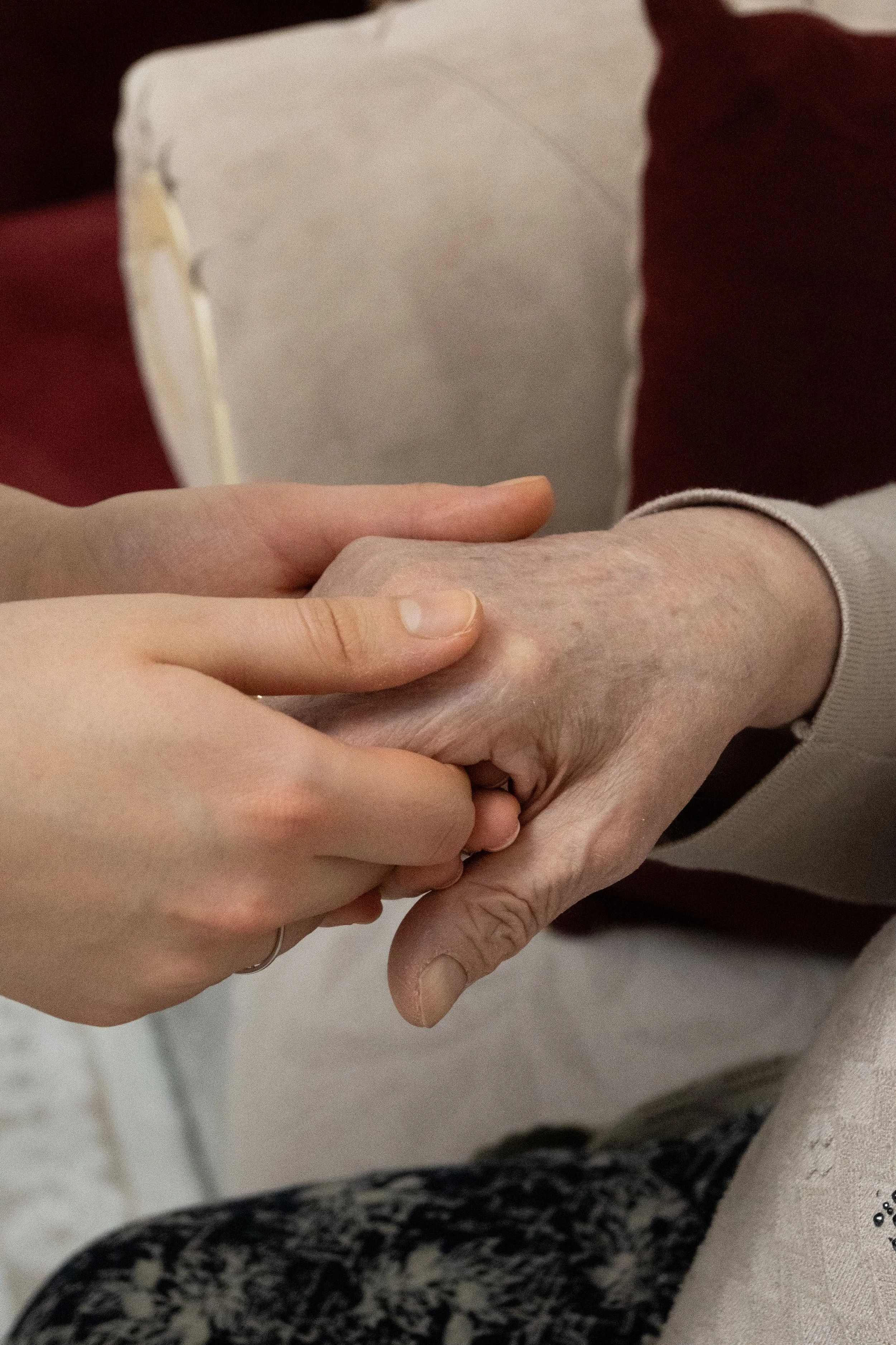 Close-up of multiple hands holding each other, showing a supportive gesture.