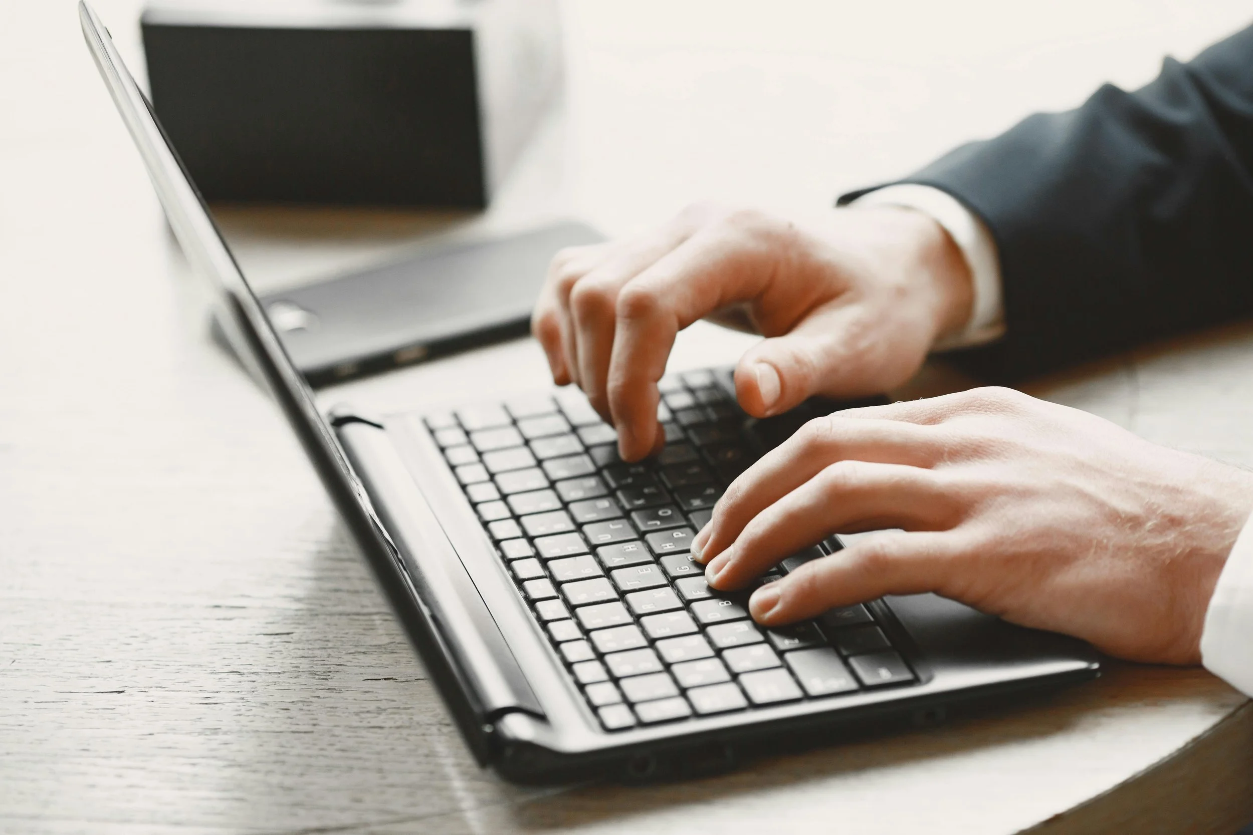 Person typing on a laptop at desk