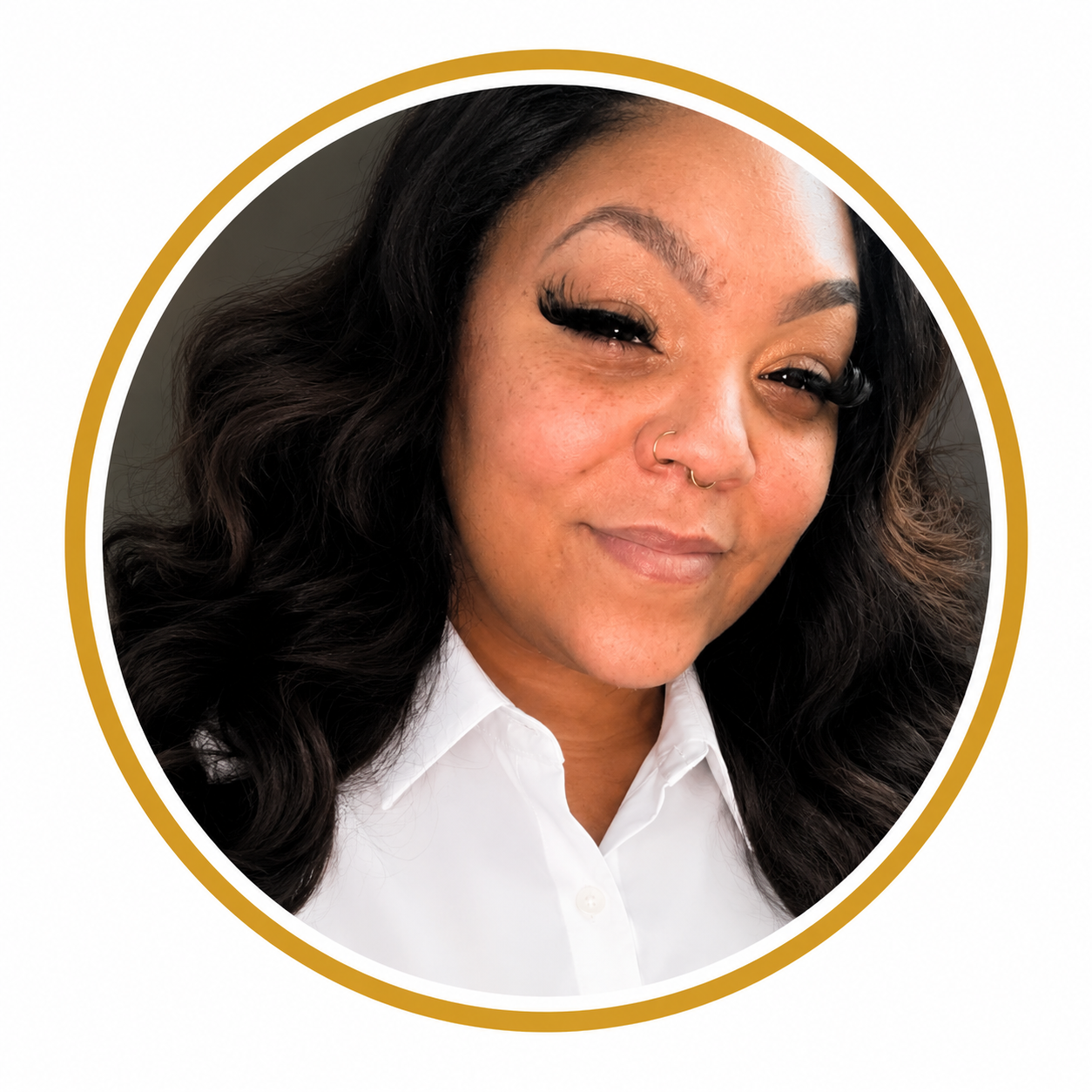 Close-up portrait of a woman with dark, wavy hair, wearing a white collared shirt, gold hoop septum piercing, and dramatic eyeliner.