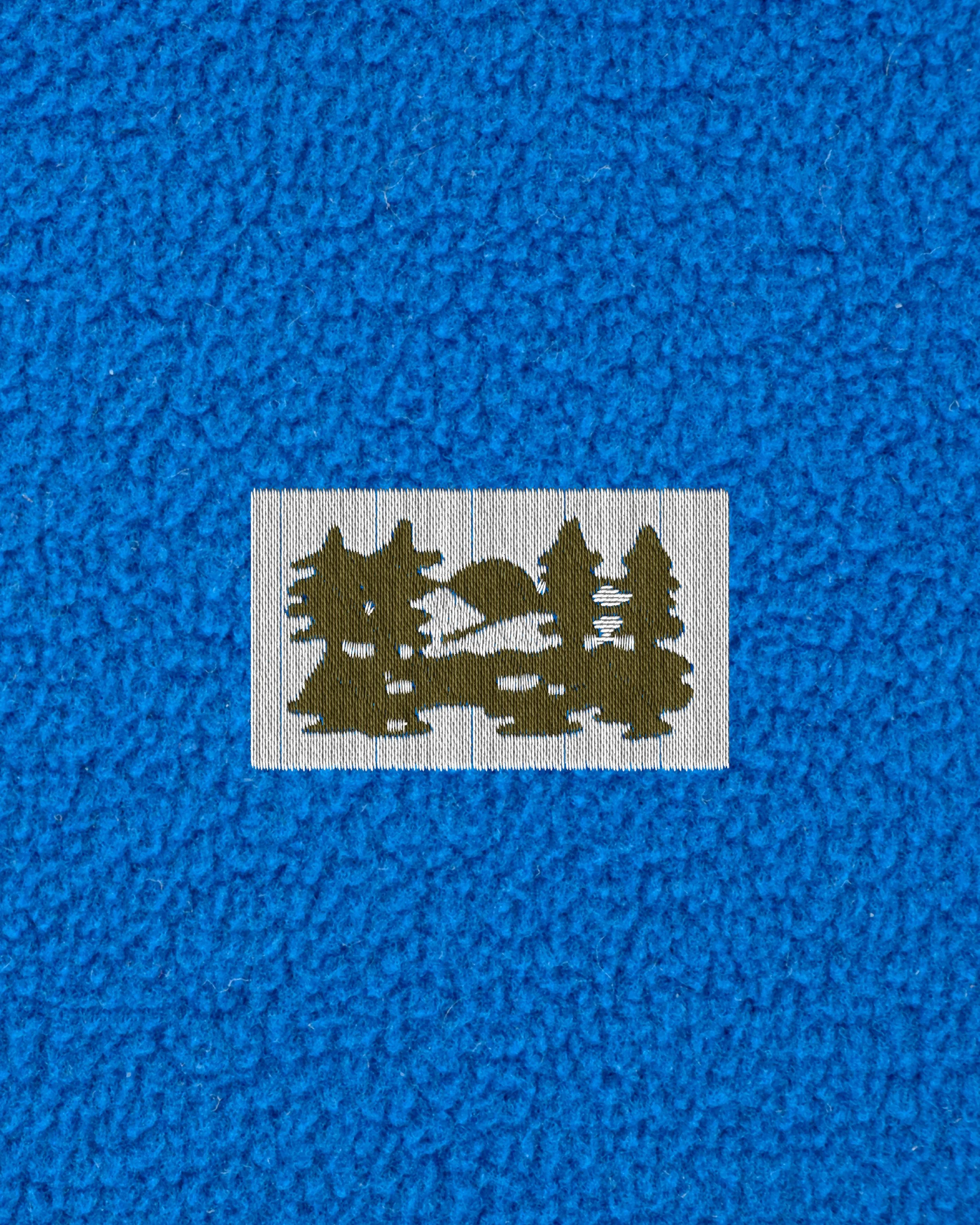 Close-up view of a piece of fabric with a printed silhouette of cats sitting on a branch.