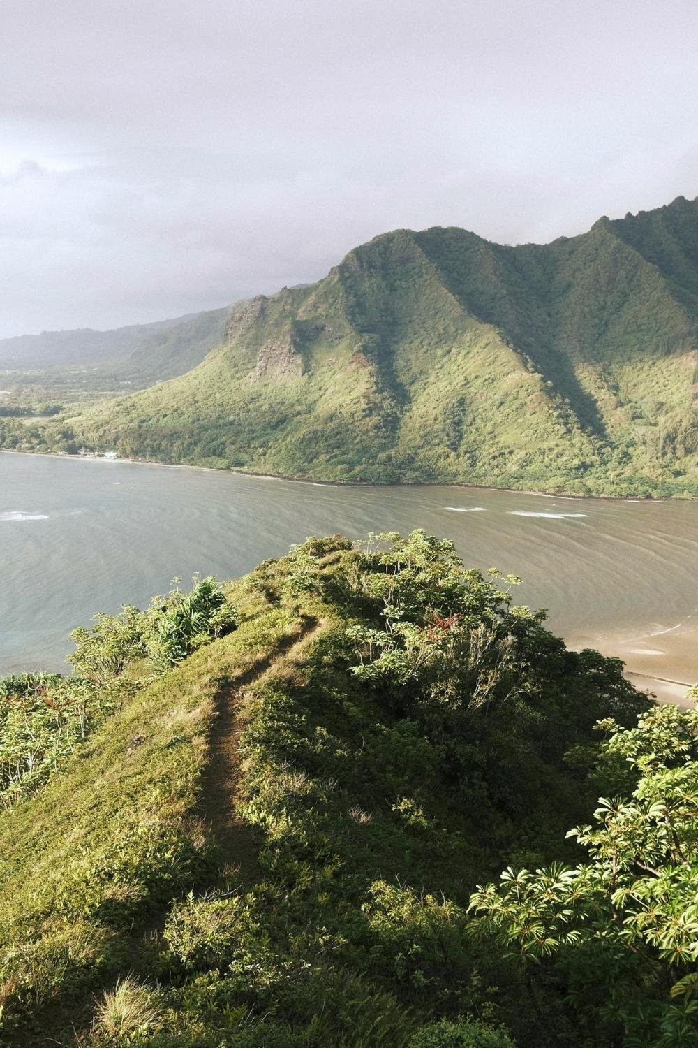 Scenic coastal mountain landscape overlooking the water, illustrating destination-driven experiential real estate and unique real estate investment opportunities in high-demand markets.