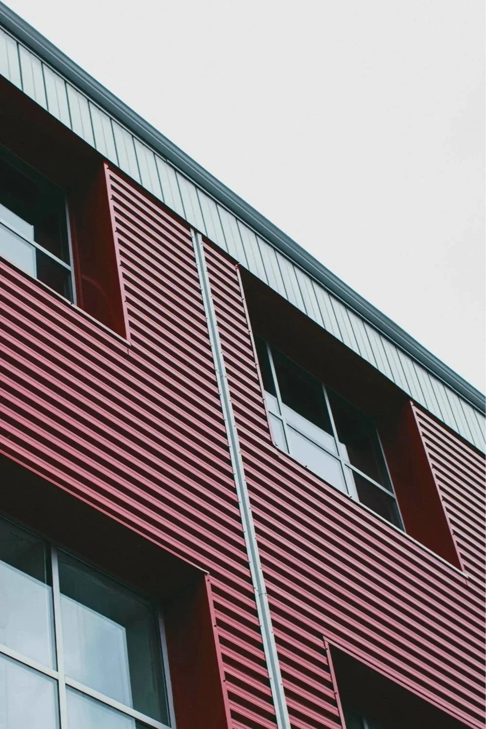 Modern mixed-use building with architectural metal cladding, representing luxury real estate development, commercial real estate asset management, and strategic long term real estate investing.