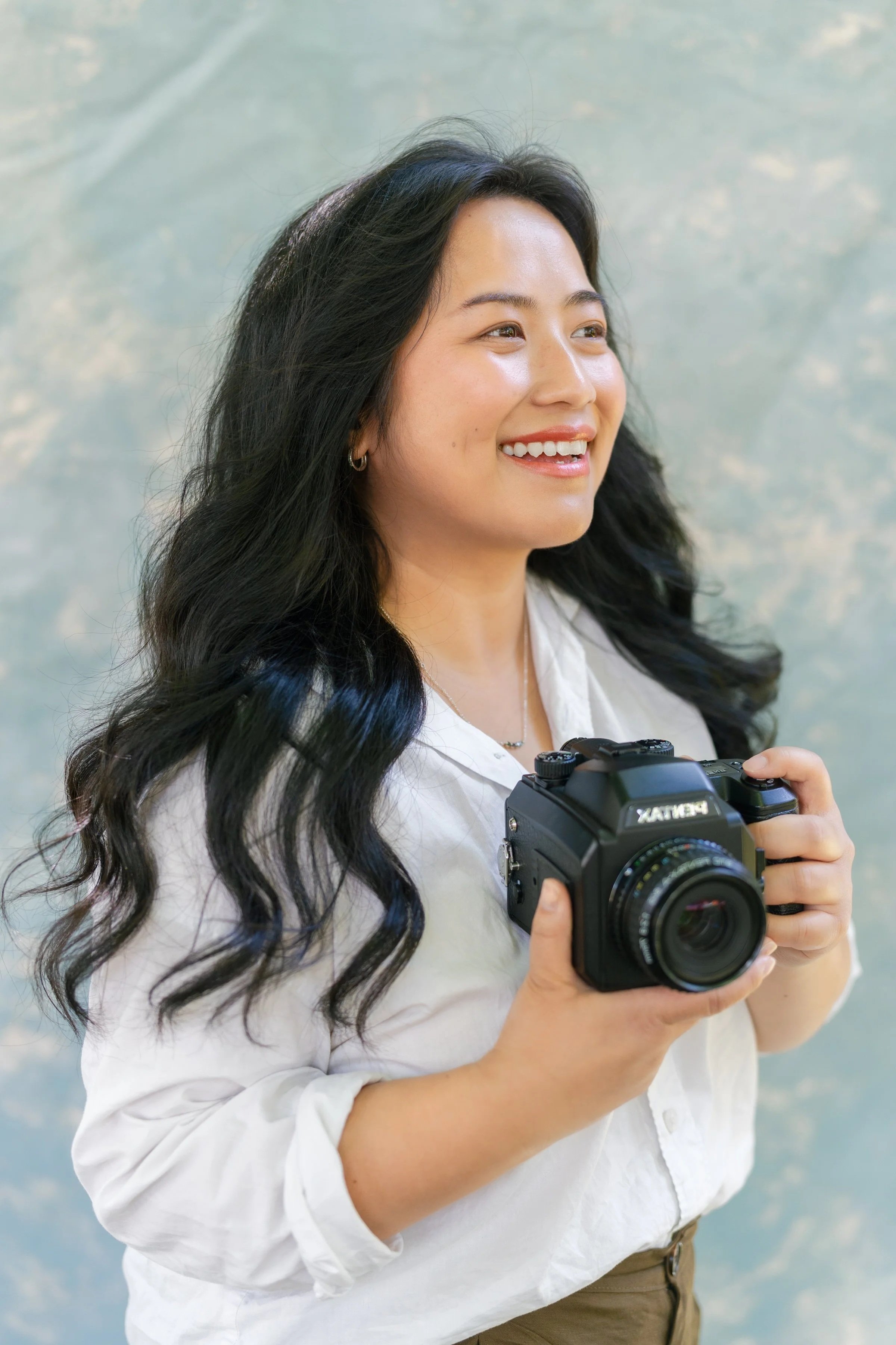 Wisconsin wedding photographer holding Pentax camera