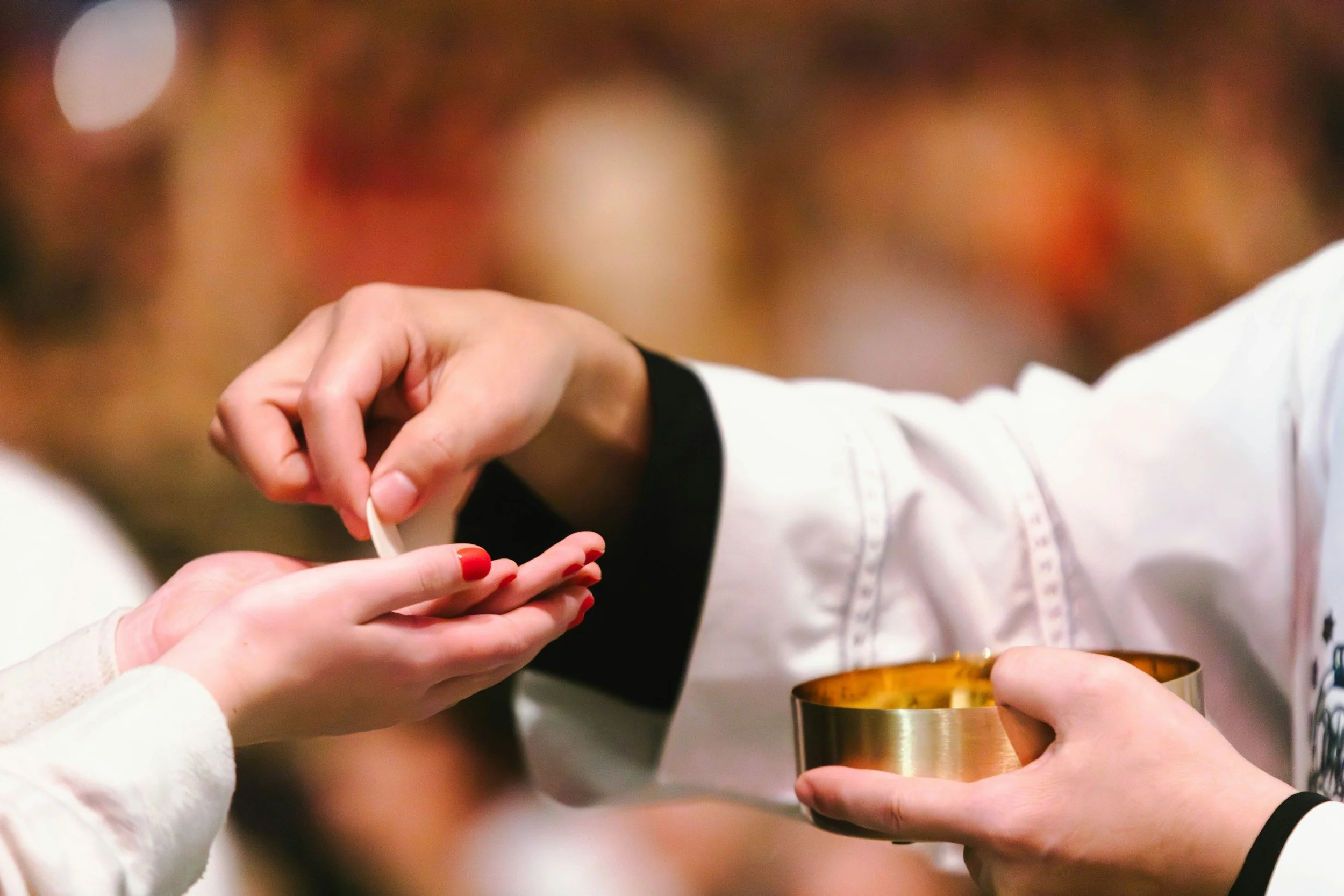 Priest administering the Eucharist.