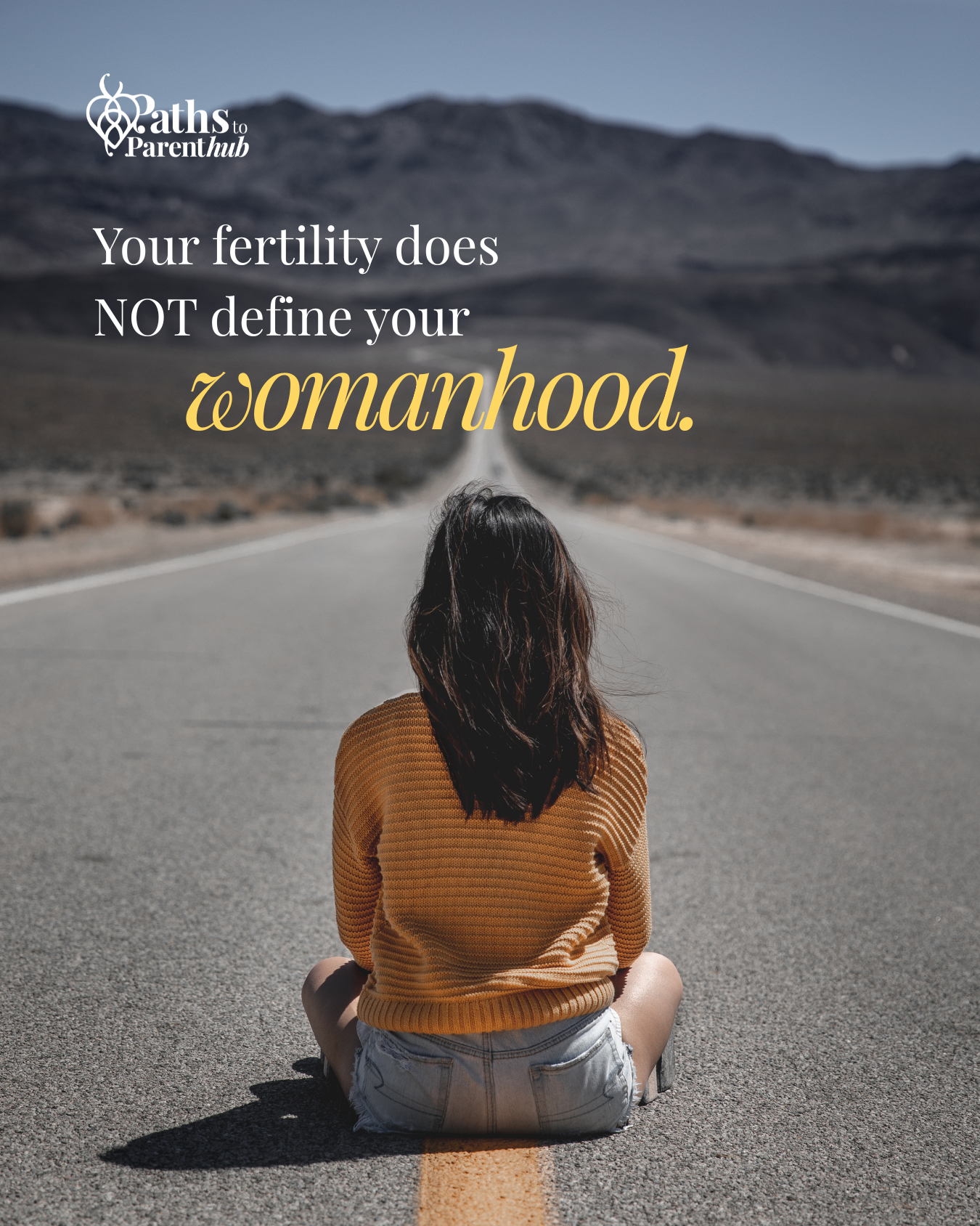 A woman sitting cross-legged on an empty road in a desert landscape, facing away from the camera, with mountains in the background, and a quote about womanhood and fertility overlaid on the image.