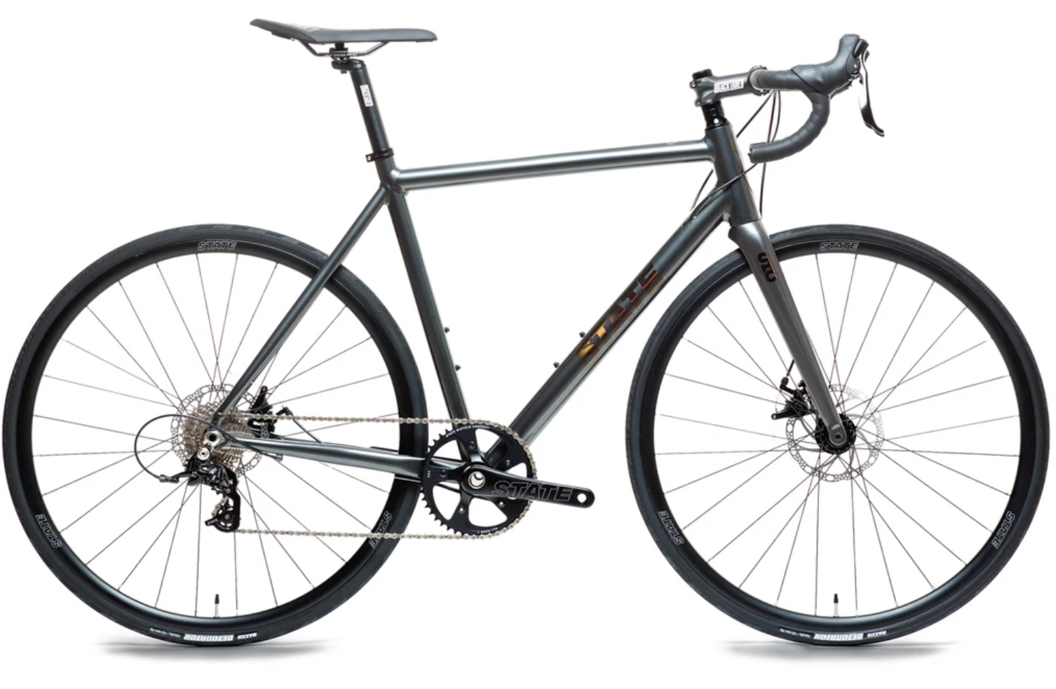 A sleek, modern gray mountain bike with thin tires, a black saddle, drop handlebars, and disc brakes, set against a plain white background.