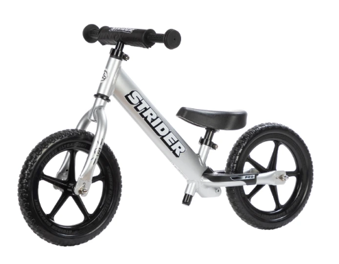 Silver and black children's balance bike with adjustable seat and foam tires.