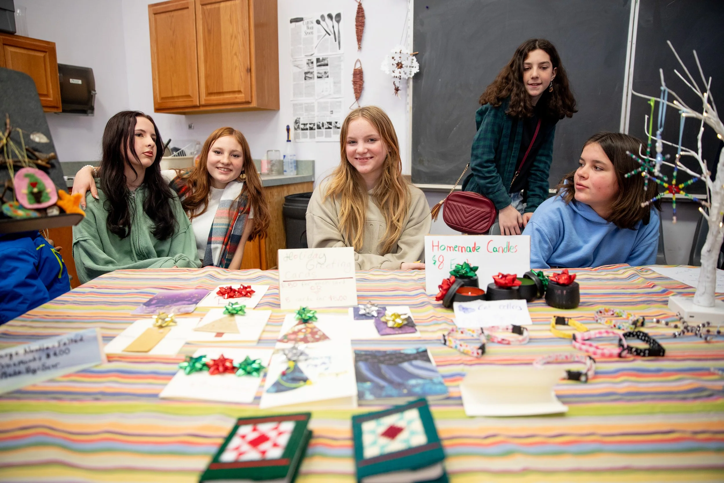 Middle school students selling handmade items at an artisan fair