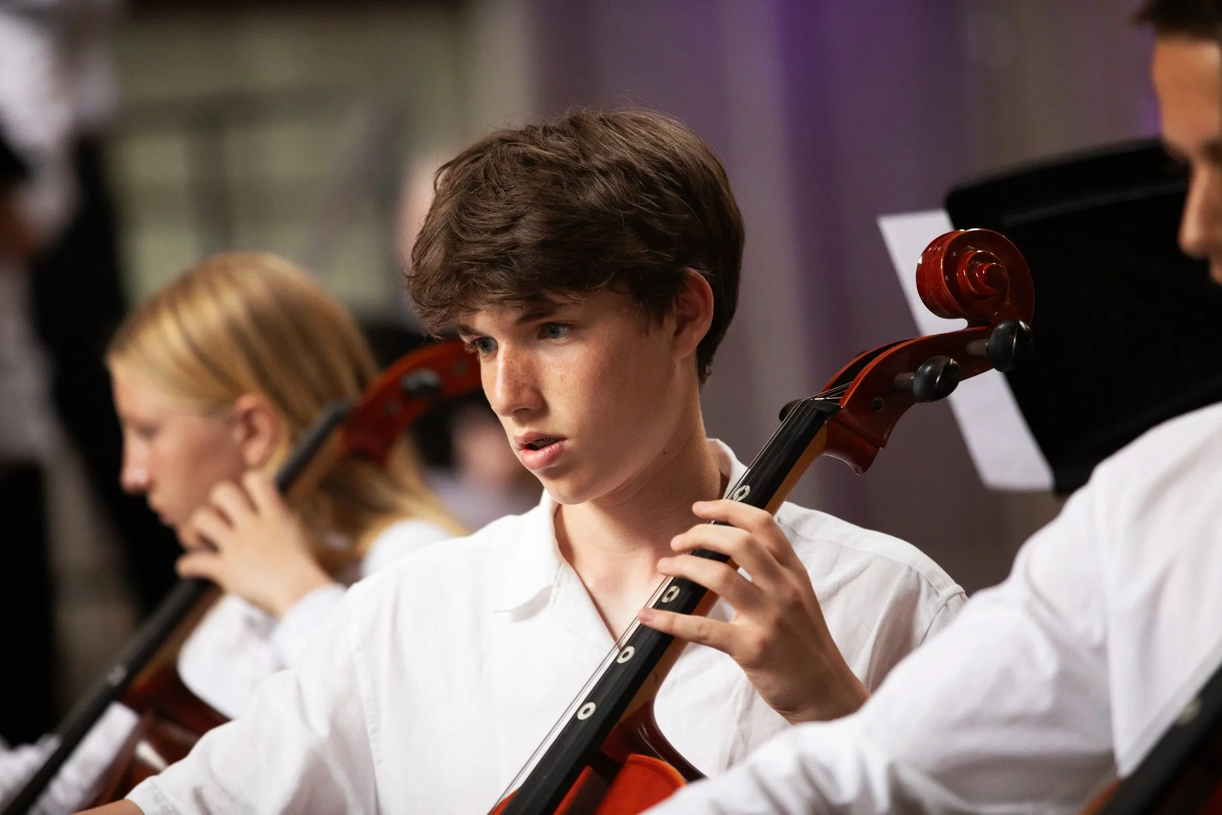 Boy playing cello in a concert