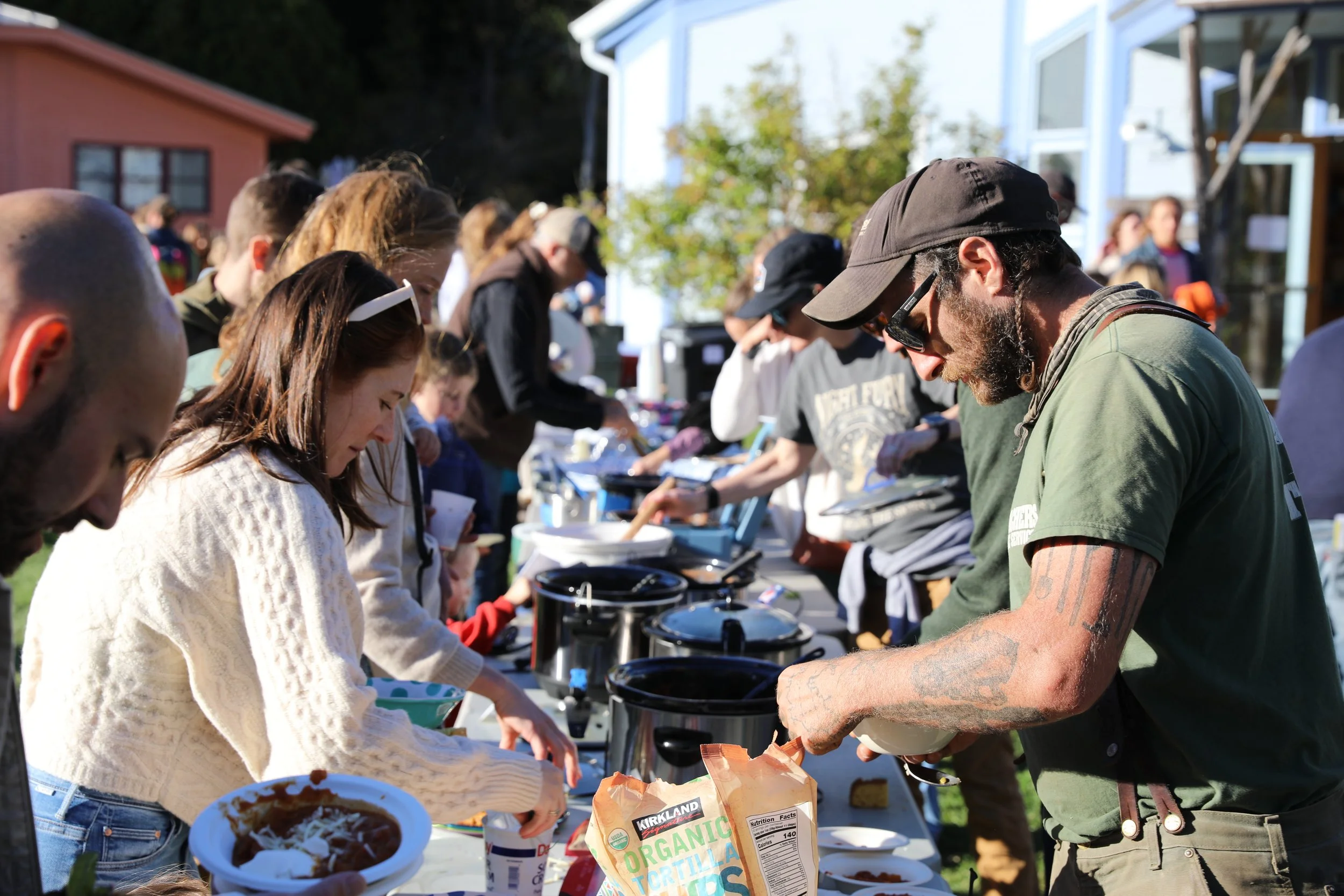 Community members sharing food at an outdoor potluck