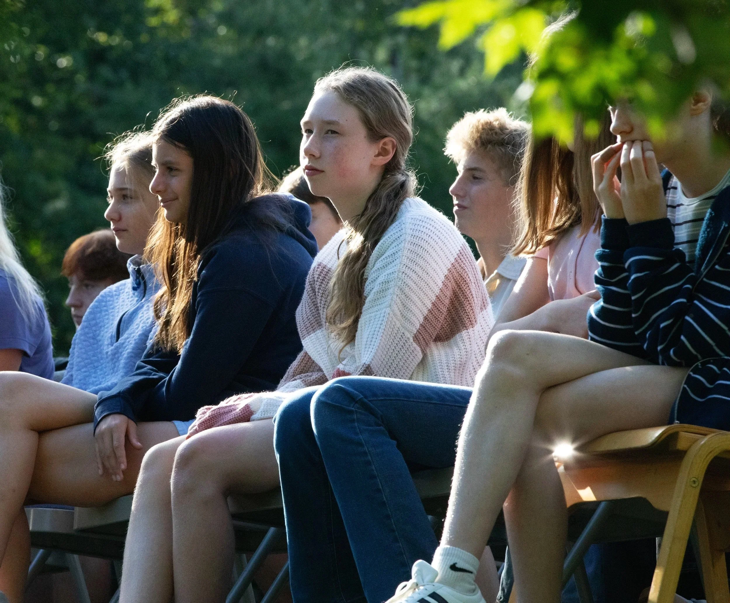 High school students sitting outside at a school event
