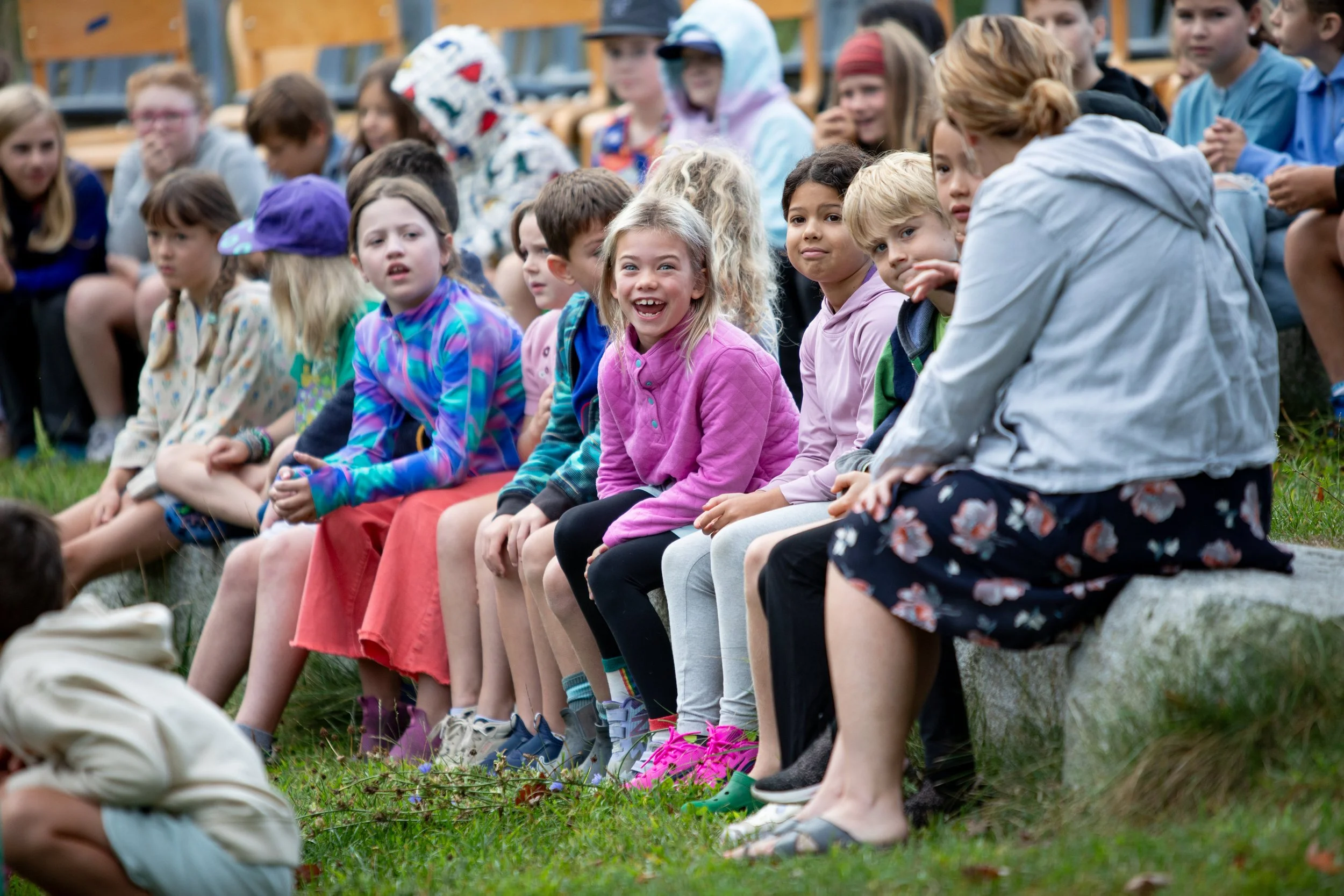 Grade school students smiling at an outdoor school event