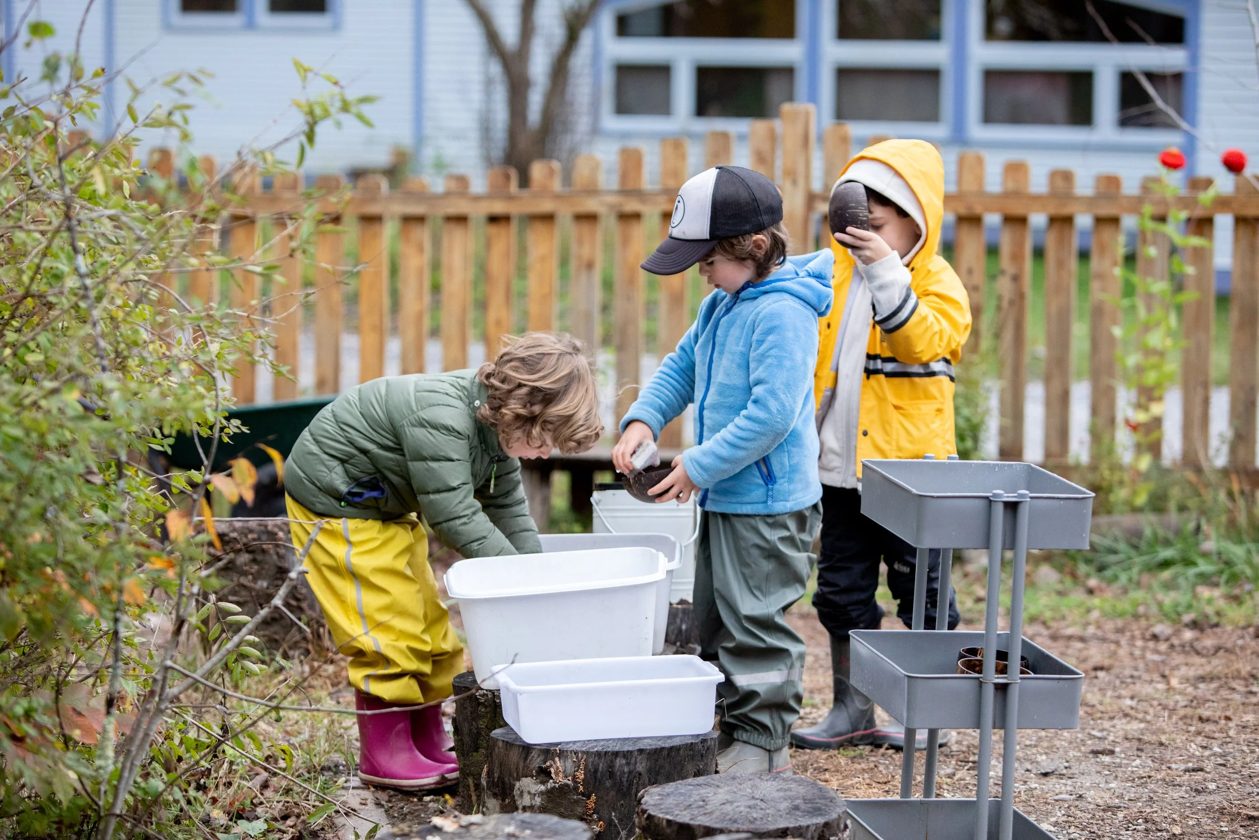 Young children playing outside in the mud