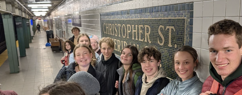 Students waiting for the subway at Christopher Street station