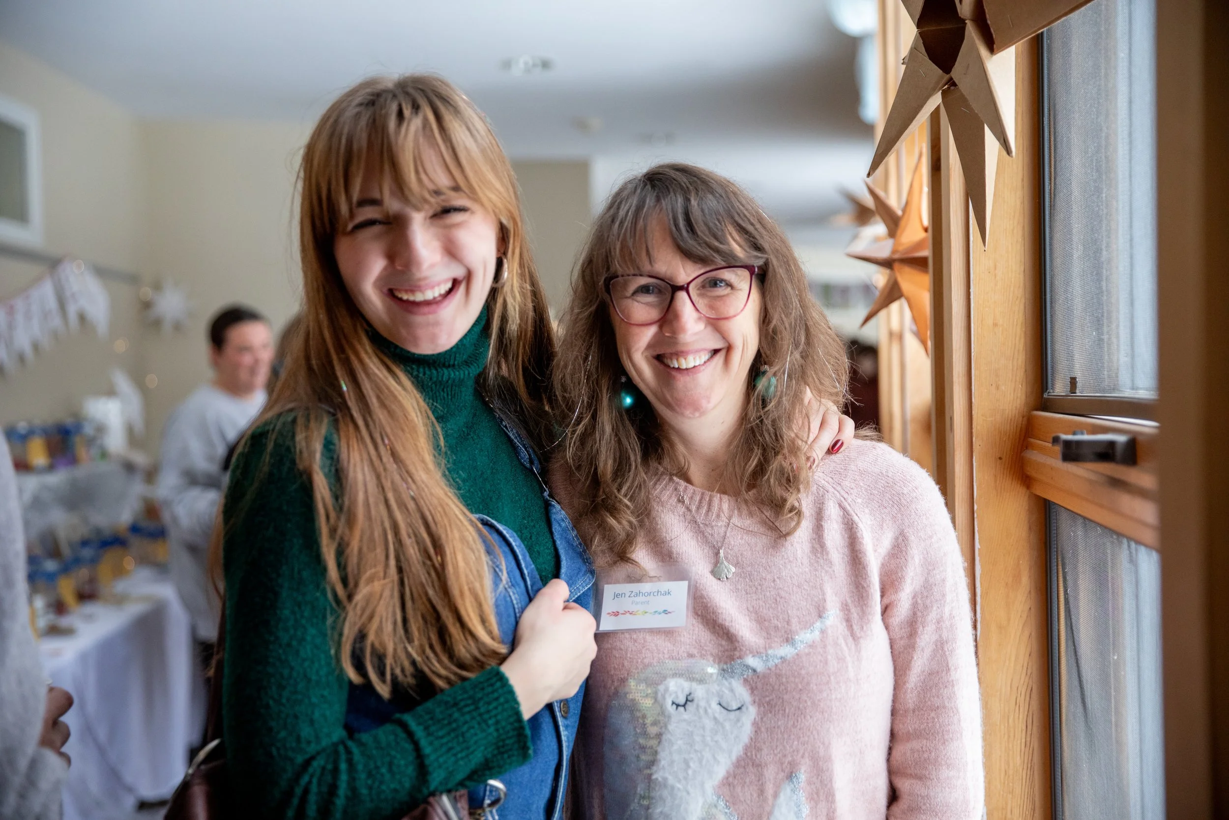 Mother and high school daughter smiling 