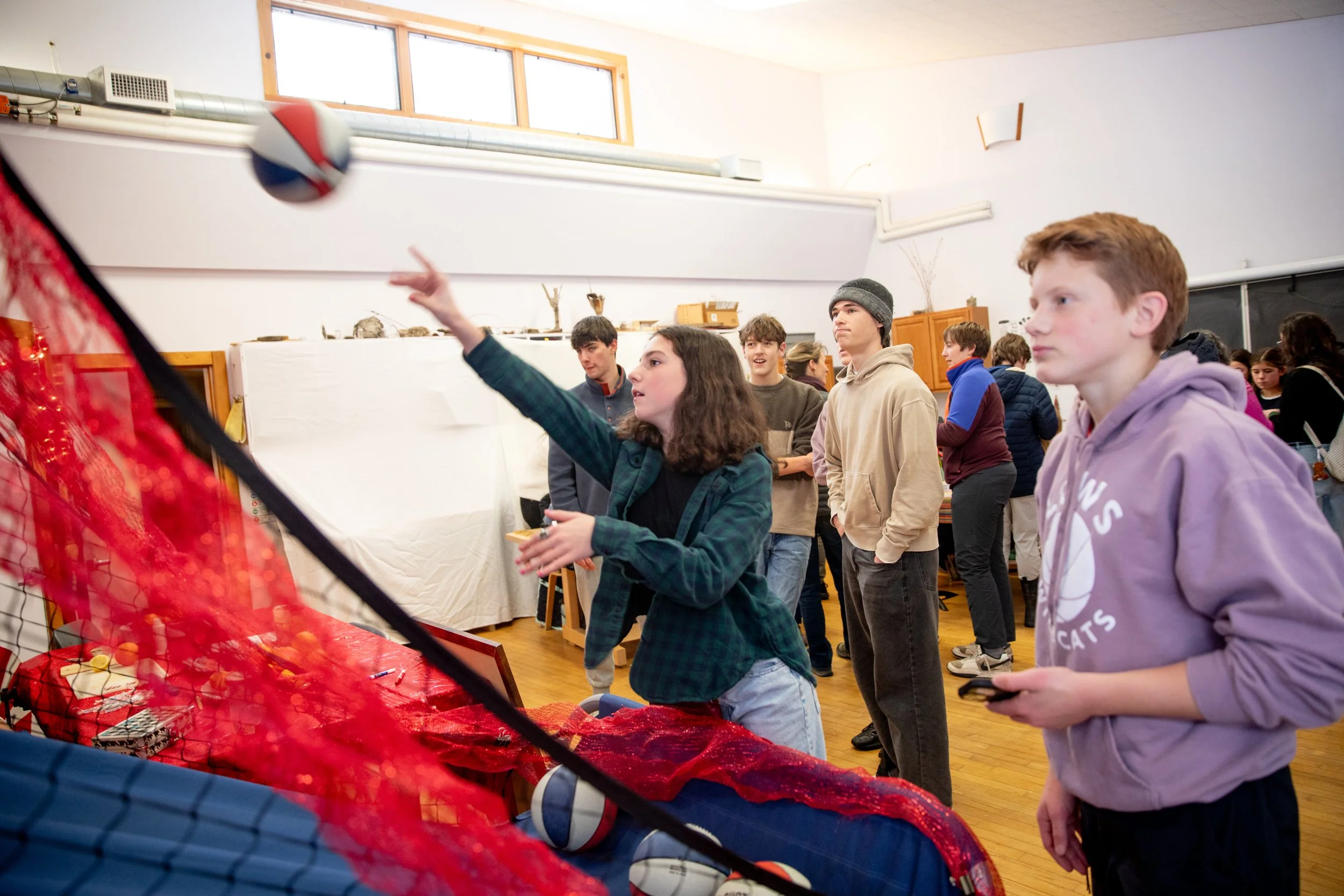 Middle school students playing basketball at a school event