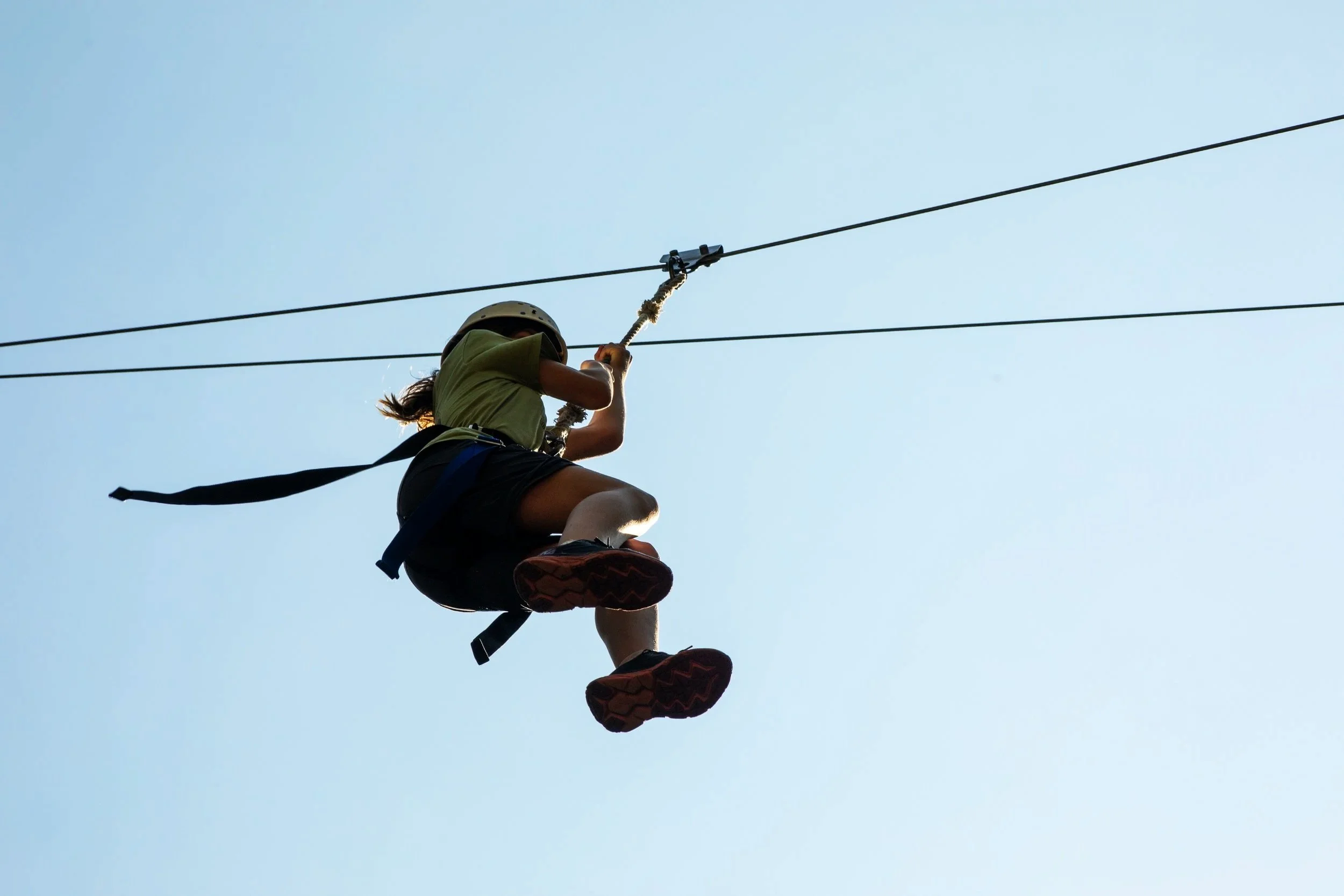 Middle school student on a zipline outside