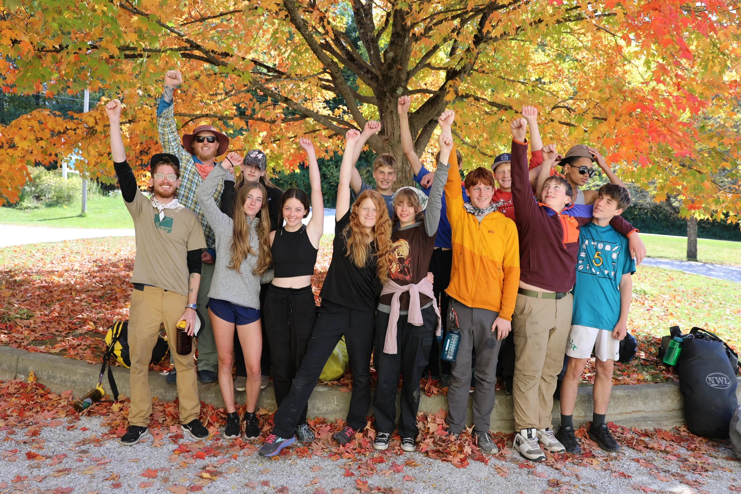 Teachers and students raising their arms in the air triumphantly