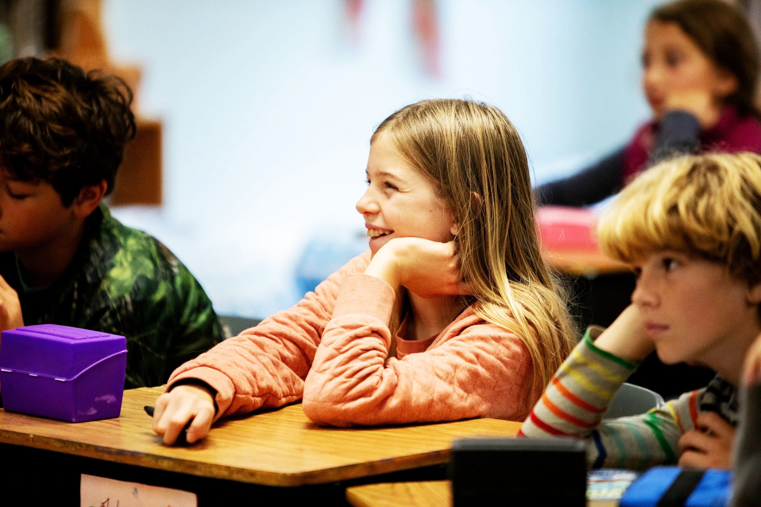 Girl smiling at her school desk
