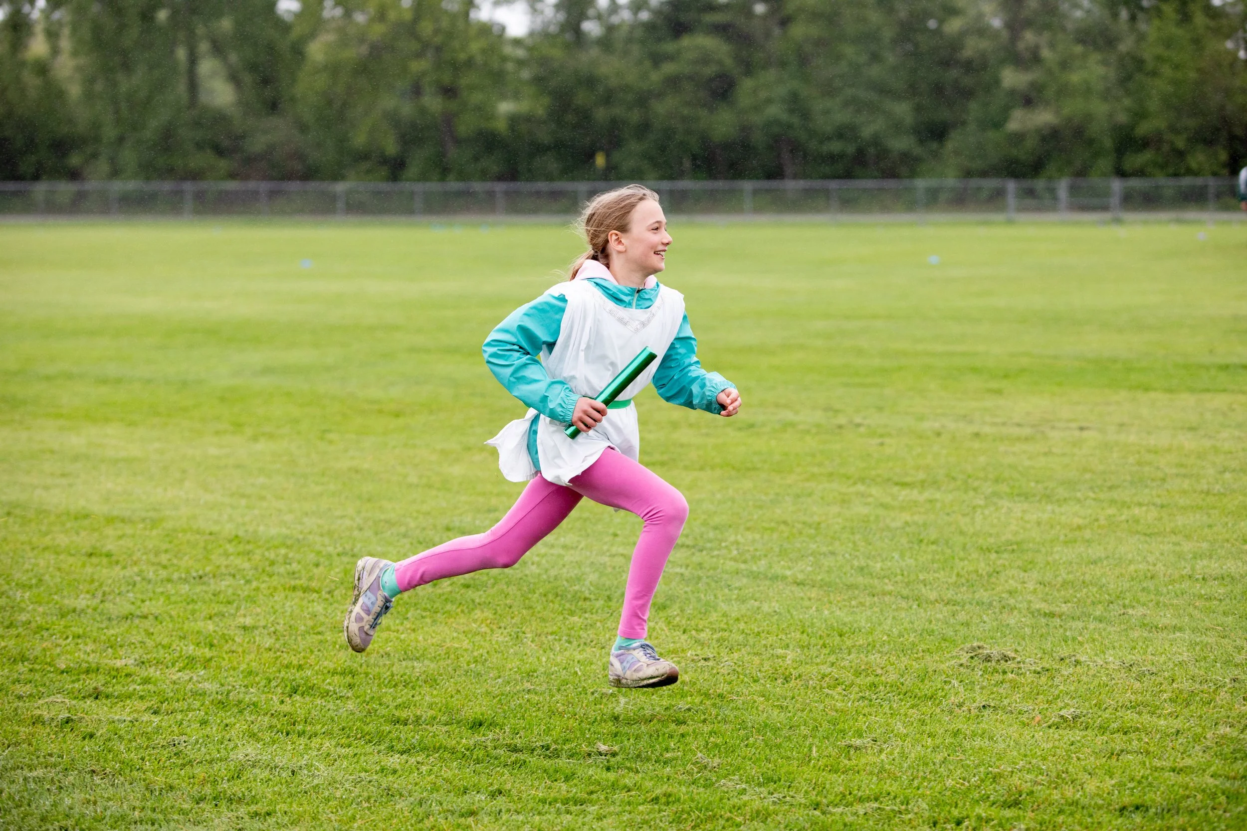 Grade school student running outdoors