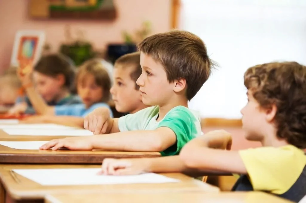 First grade students at desks in a classroom